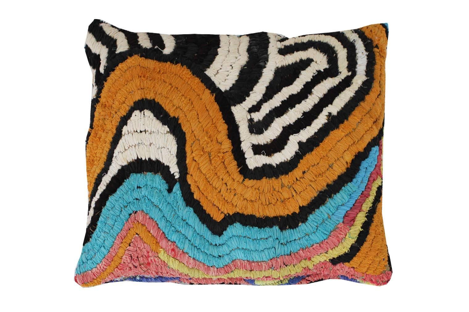 Floor pillow made with vintage Moroccan textile rug.
This pillow is black, cream and green with accents in pink, orange, aqua, blue, purple, and chartreuse.
Measures: 28" L x 25" W.