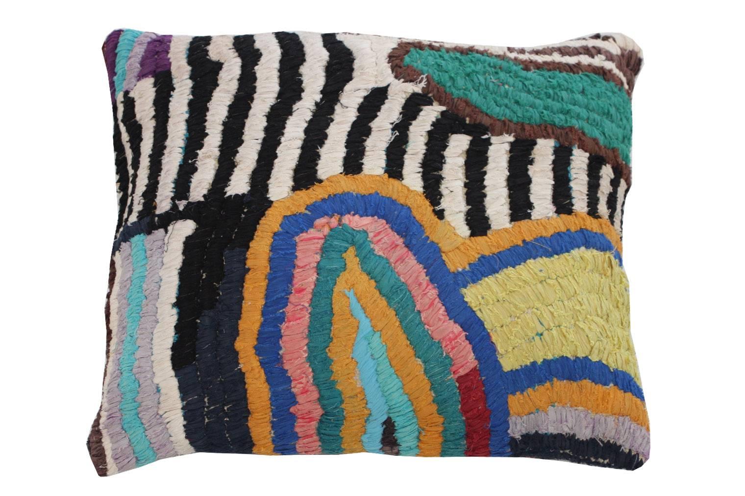 Floor pillow made with Moroccan vintage textile rug. 
This pillow is black, brown and cream with accents of pink, orange, aqua, blue, purple, chartreuse and red.
28" L x 25" W.