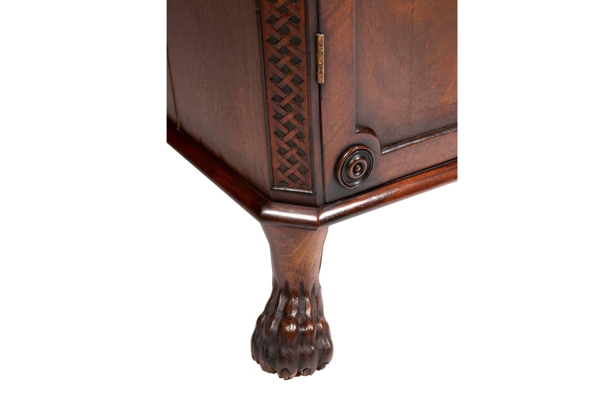 19th century Regency pair of mahogany pedestals. The reeded top above cupboard doors, with fitted drawer and brass pull raised on hairy paw feet.