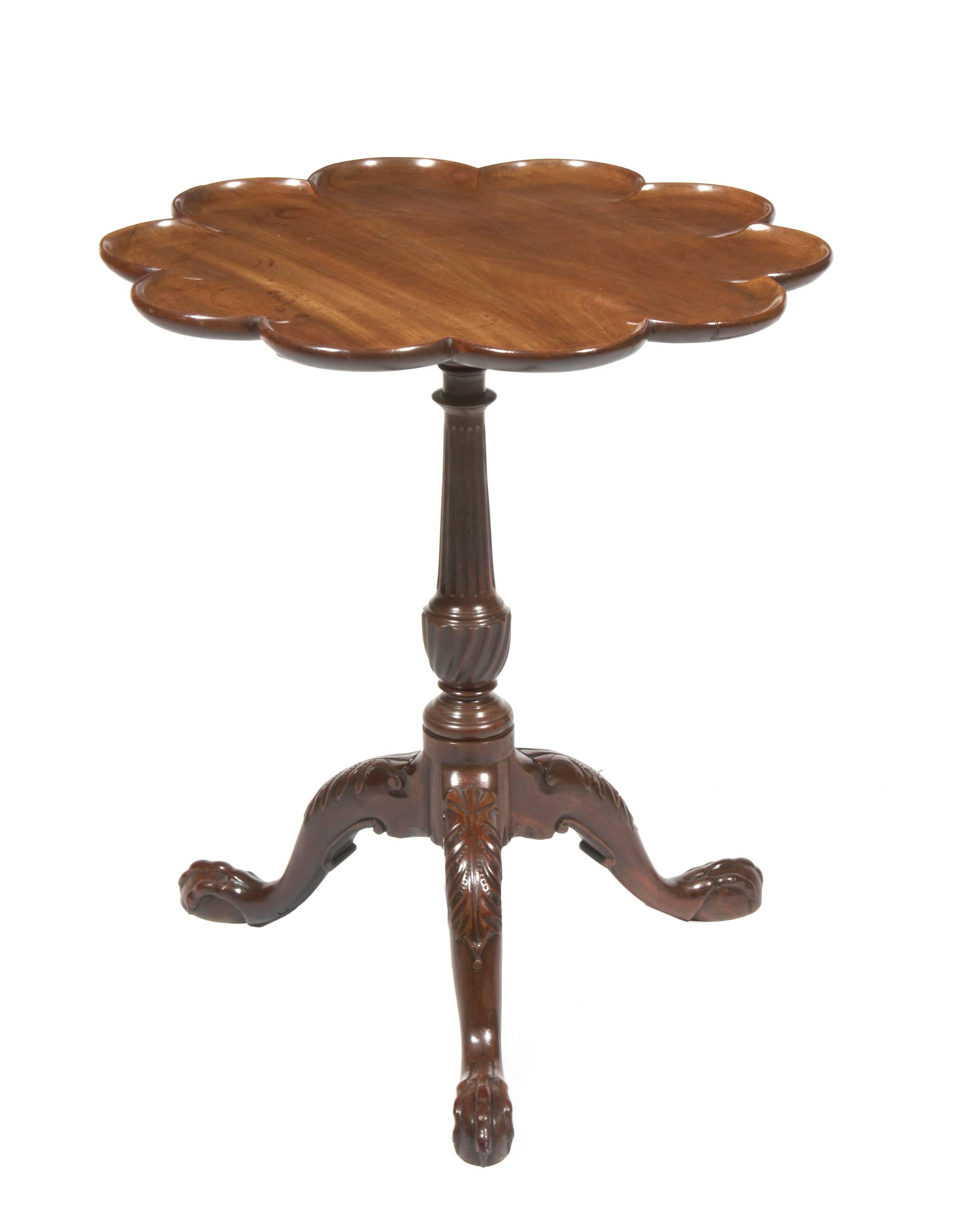 18th Century George III mahogany petal tripod wine table, the circular petal top raised on turned and reeded column supported on three cabriole legs with acanthus carving on knee terminating in ball and claw foot, circa 1760.