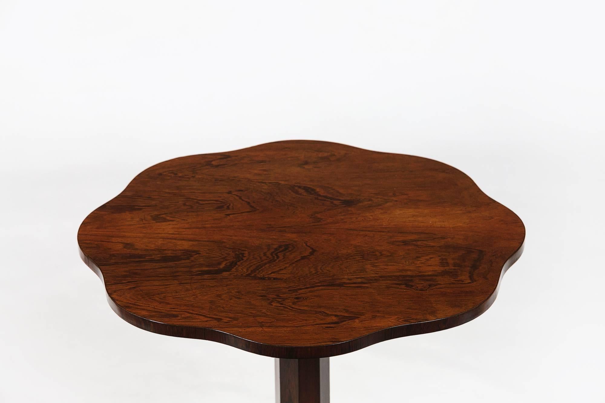 Early 19th century George III mahogany occasional table with shaped top standing on a beautiful carved tripod base.