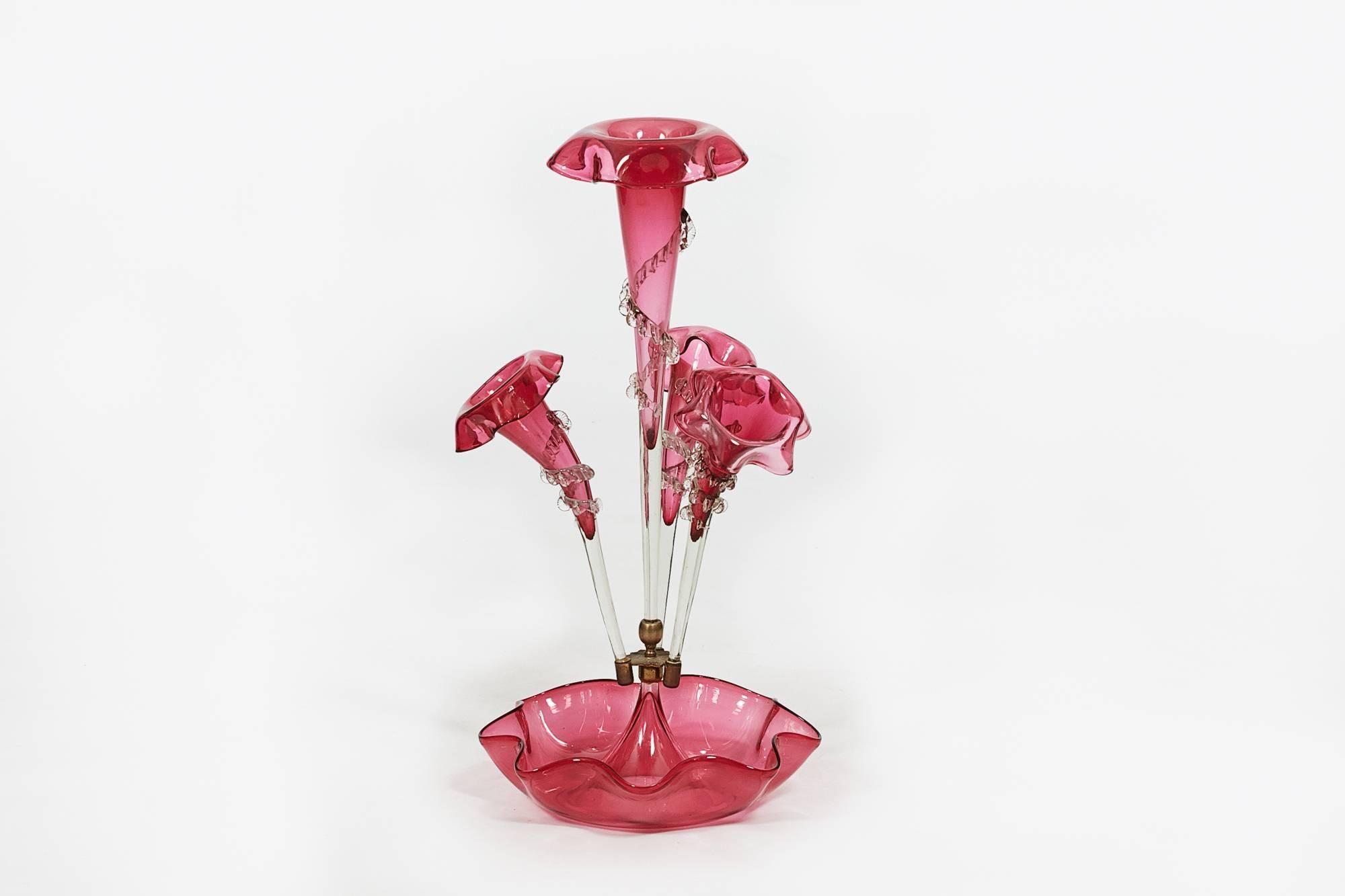 19th century cranberry glass epergne, with central large trumpet and three smaller trumpets on fluted bowl.