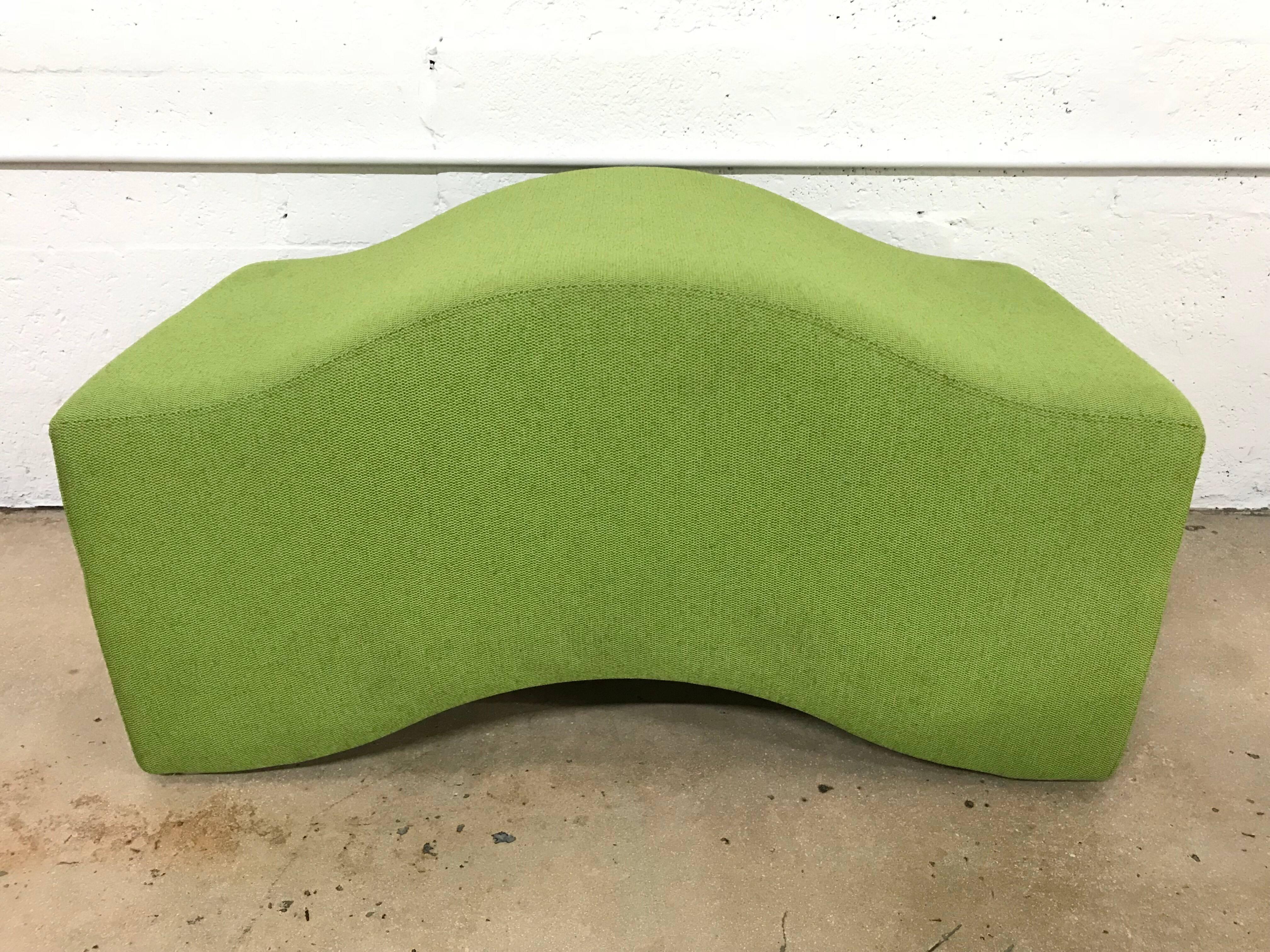 Undulating wave bench designed by Laurinda Spears for Steelcase. Composed of three separate units rendered in green, orange, and blue fabric over a foam structure.
