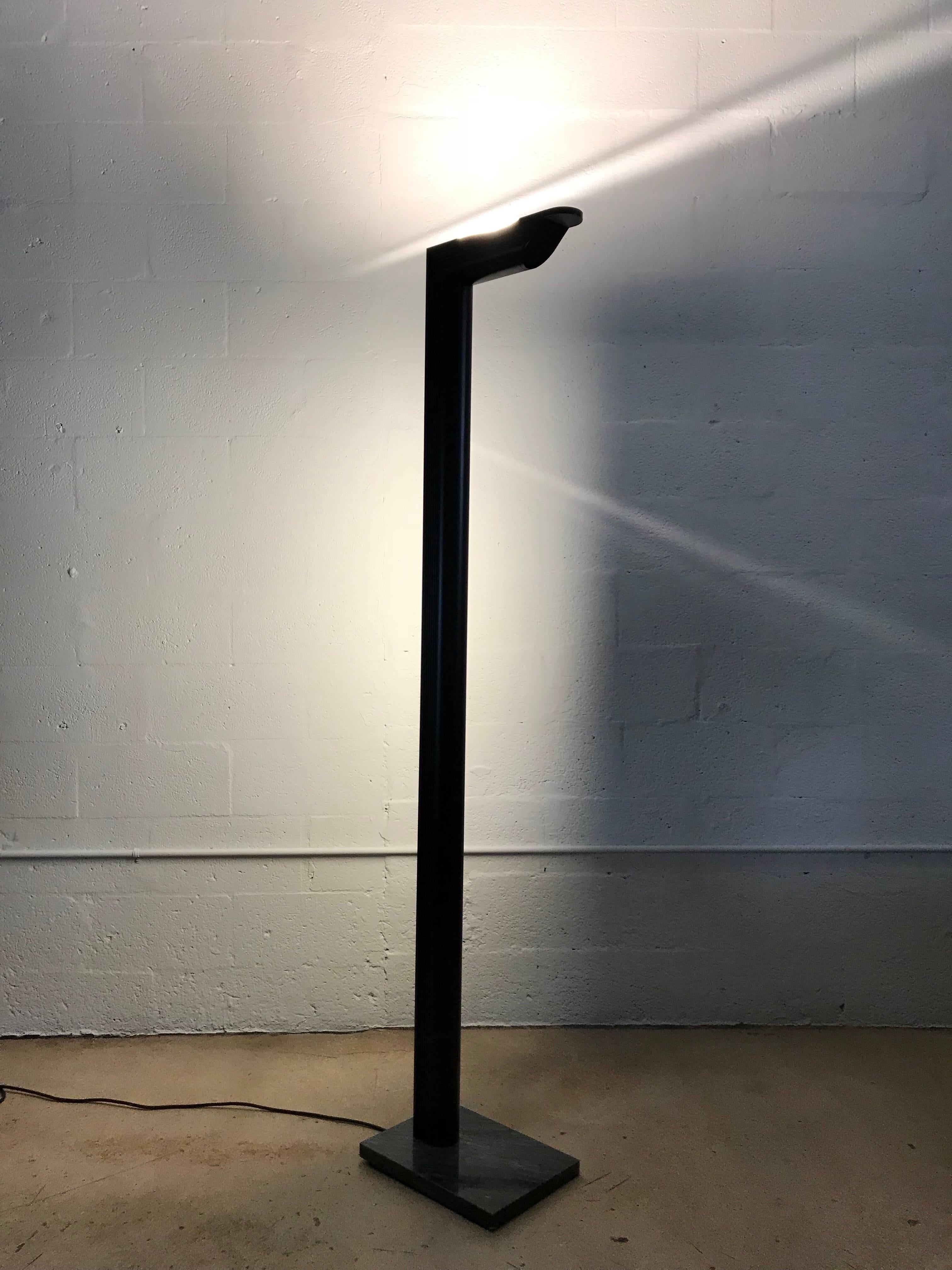 Black Postmodern floor lamp, with a marble base and light sources from the rear and top.