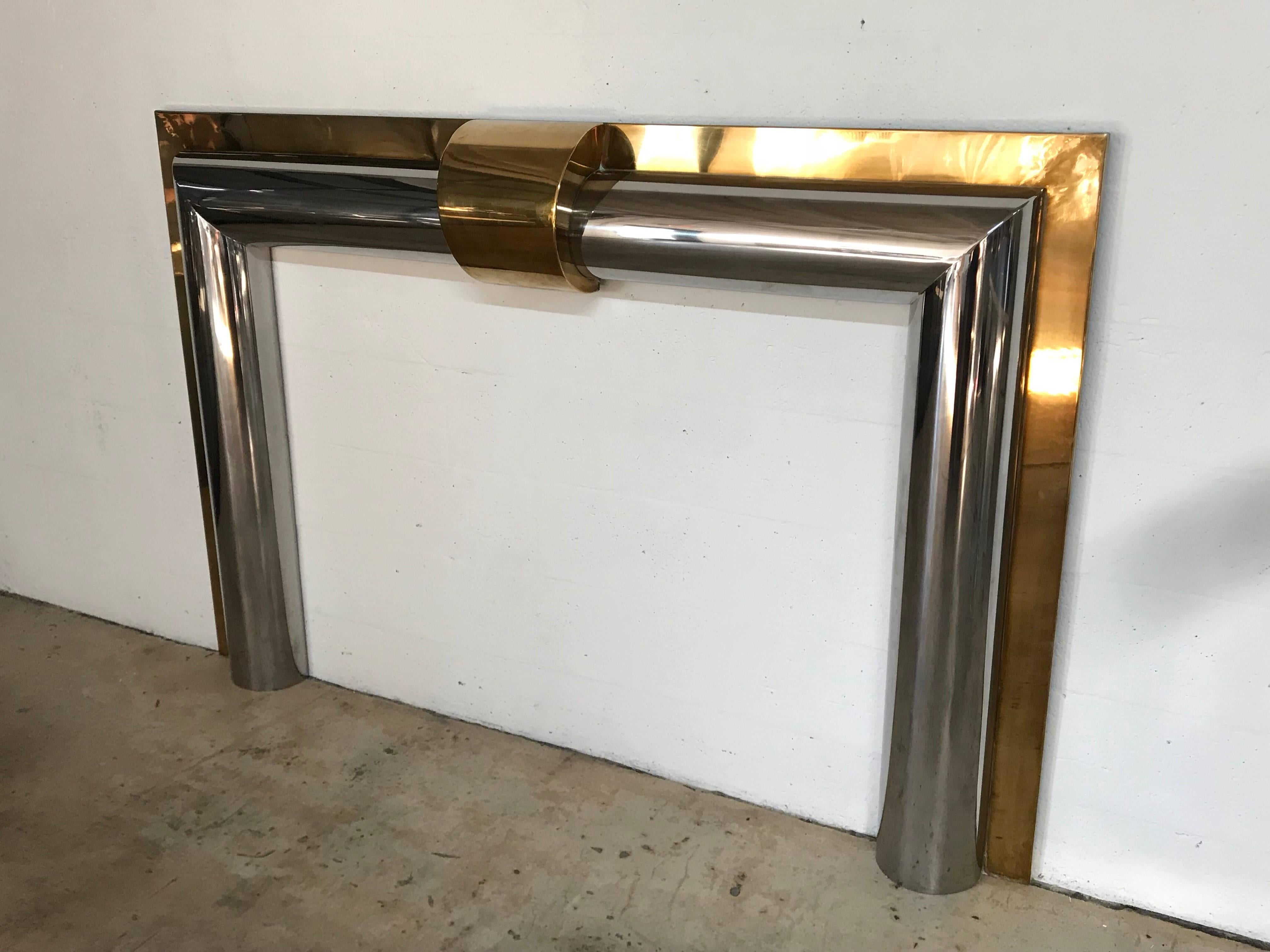 Polished brass and steel fireplace mantel, custom-made in 1970 for a waterfront mansion in Palm Beach.

Images are post removal from estate, current condition differs, brass has patina and tarnish, contact dealer for updated images.

Fire box