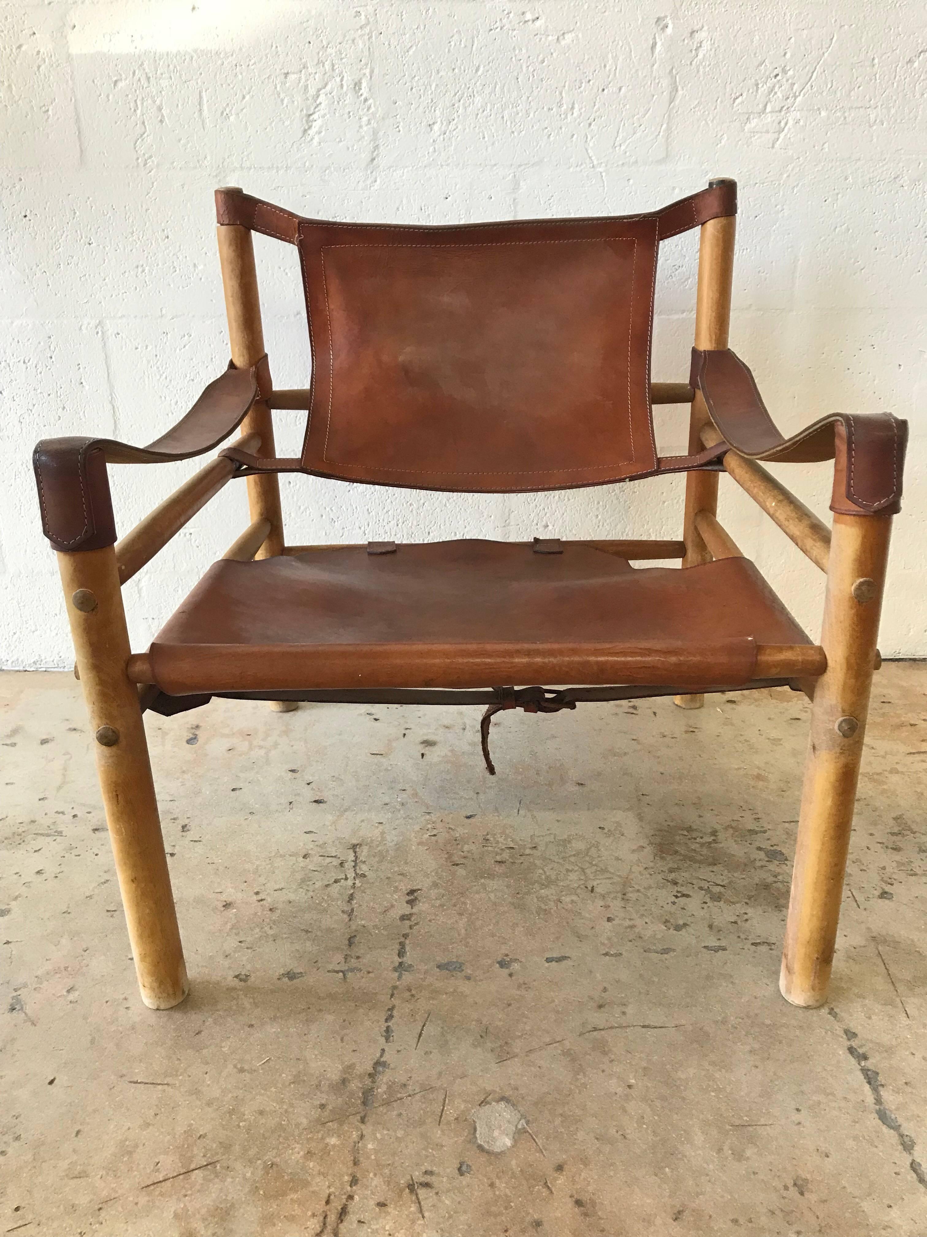 Early original distressed saddle leather Sirocco, safari, Campaign armchair designed by Arne Norell.