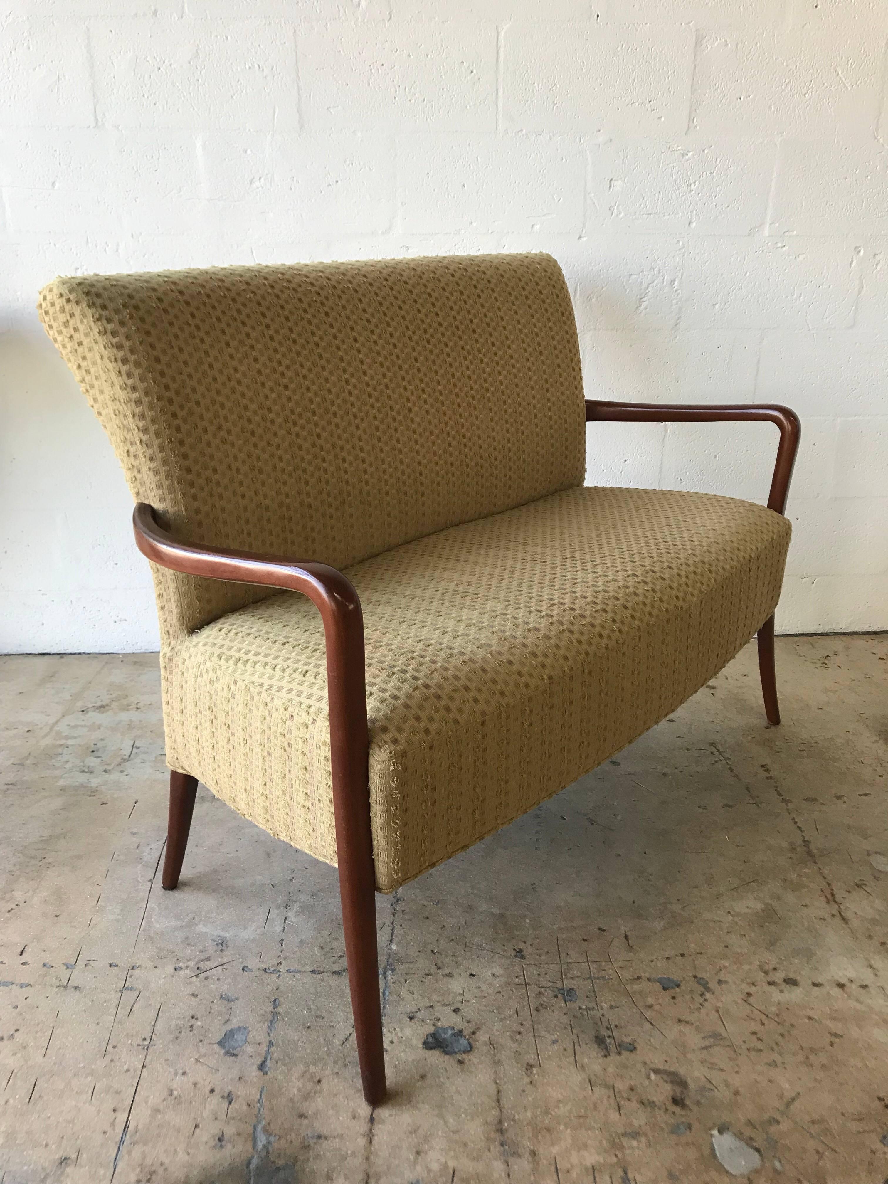 Midcentury Italian sofa settee or loveseat in the style of Paolo Buffa, walnut legs and arms, with cotton upholstery.