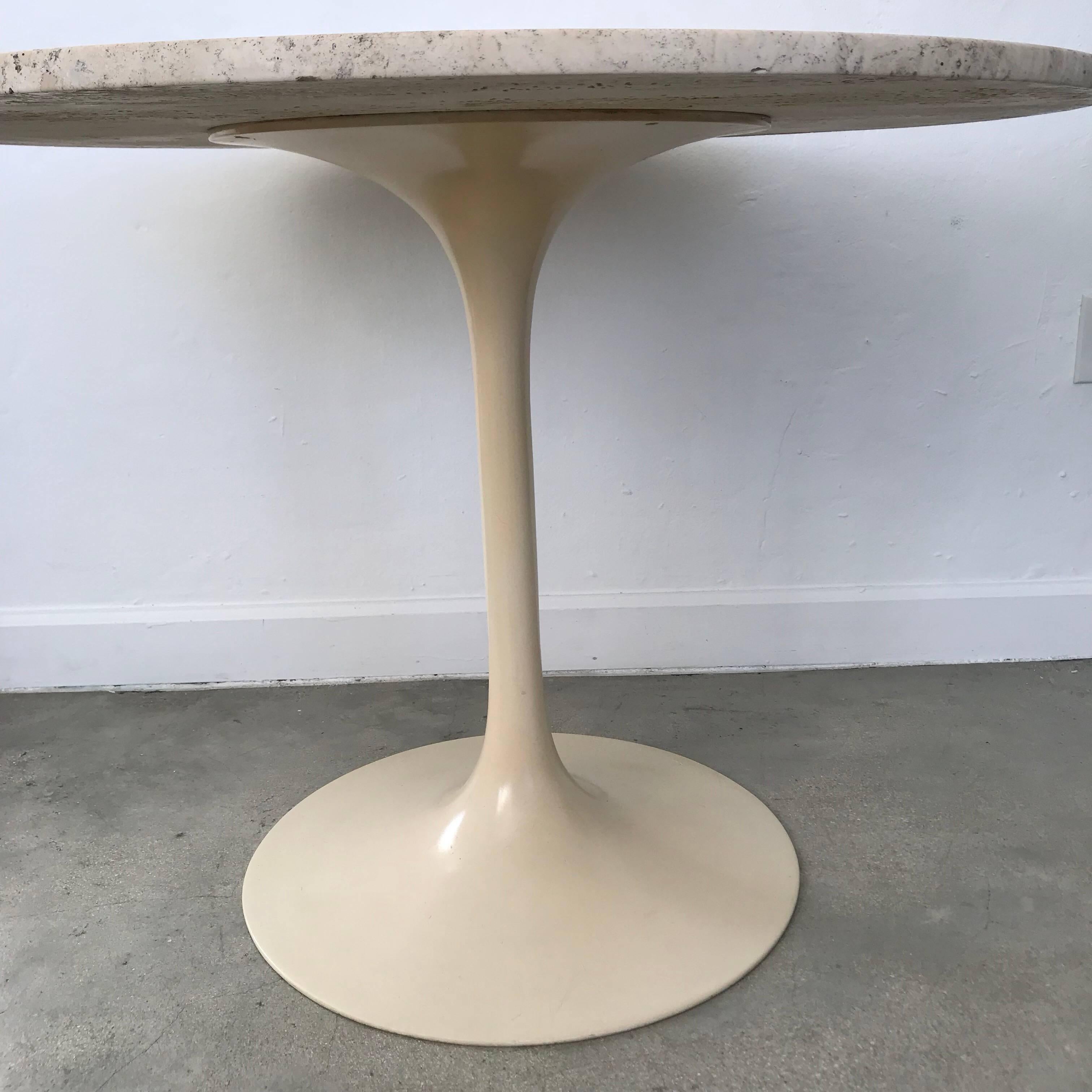 Tone on tone travertine top and cream powder coated tulip base dining or centre table designed by Maurice Burke for Arkana.