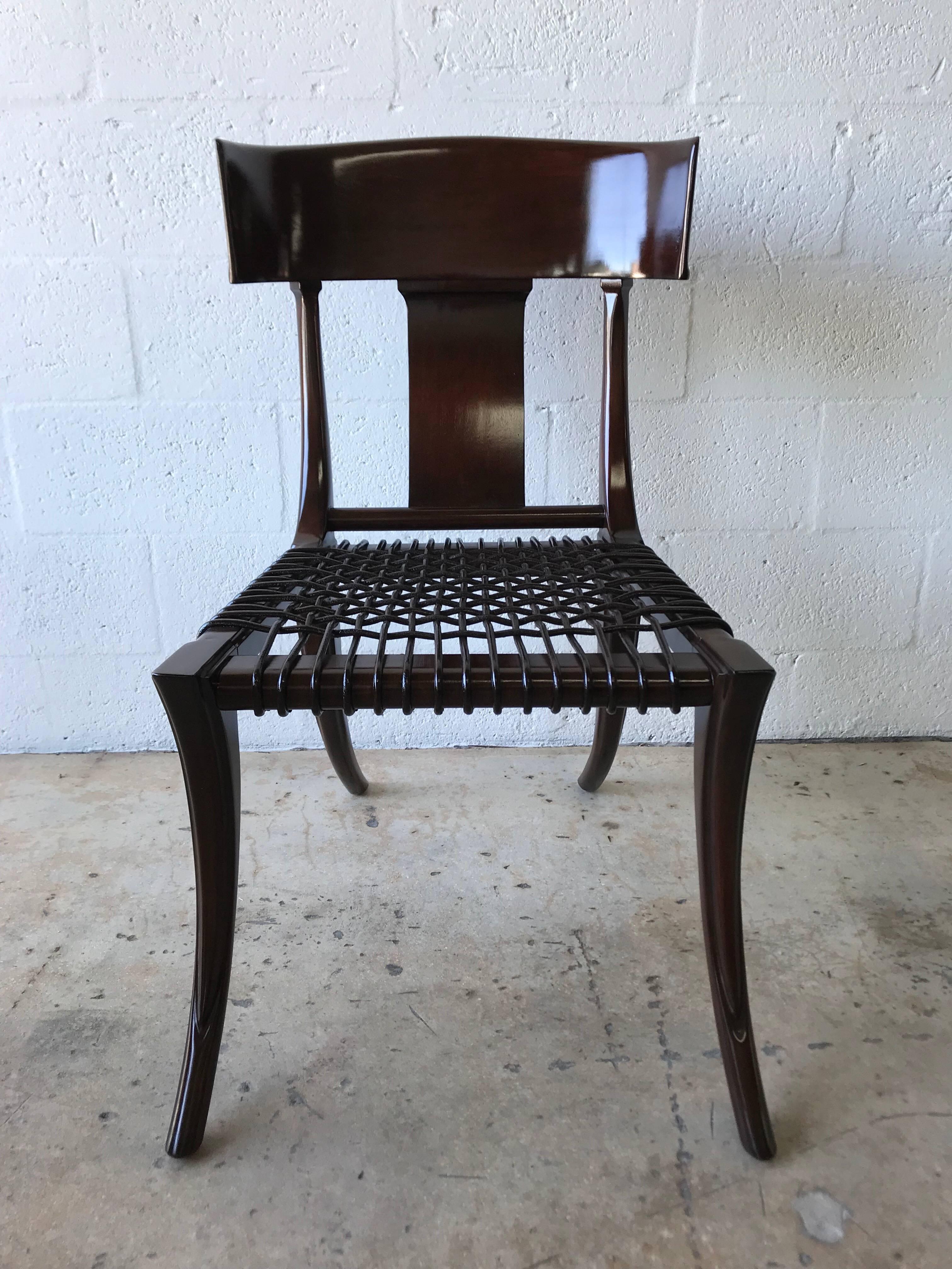 Rare Klismos chair with splayed saber legs and leather woven seat designed by T.H. Robsjohn-Gibbings for Saridis Greece.

Measures: seat height 16.75 inches.