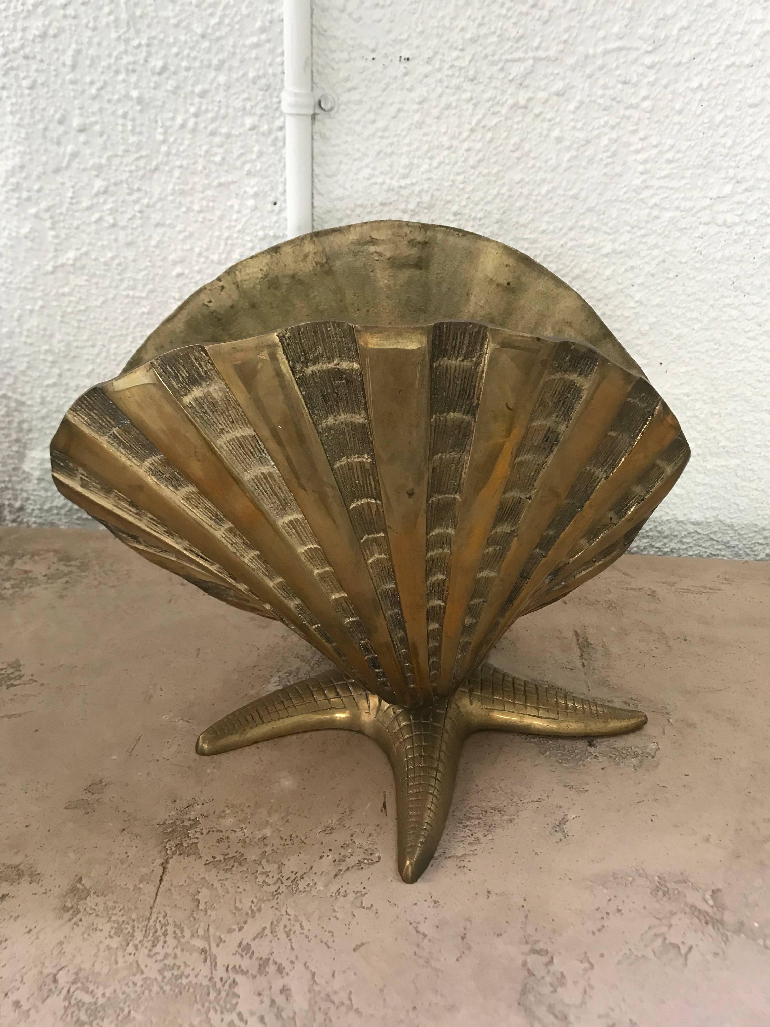 Brass lamp with a nautical motif of a starfish base and shell light enclosure.
