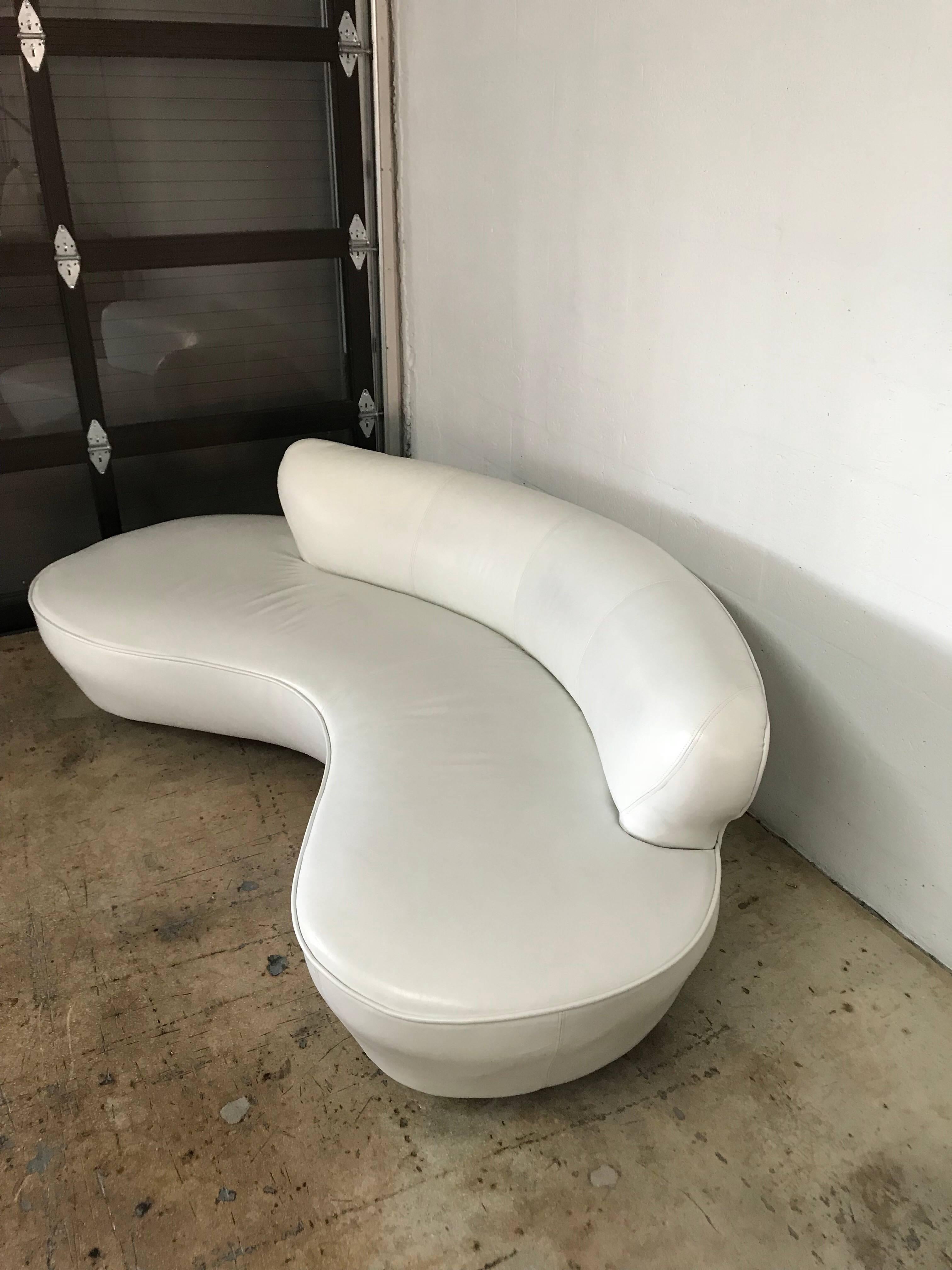Original white leather serpentine sofa designed by Vladimir Kagan for Directional, base consist of two white leather wrapped pedestals and Lucite center support.