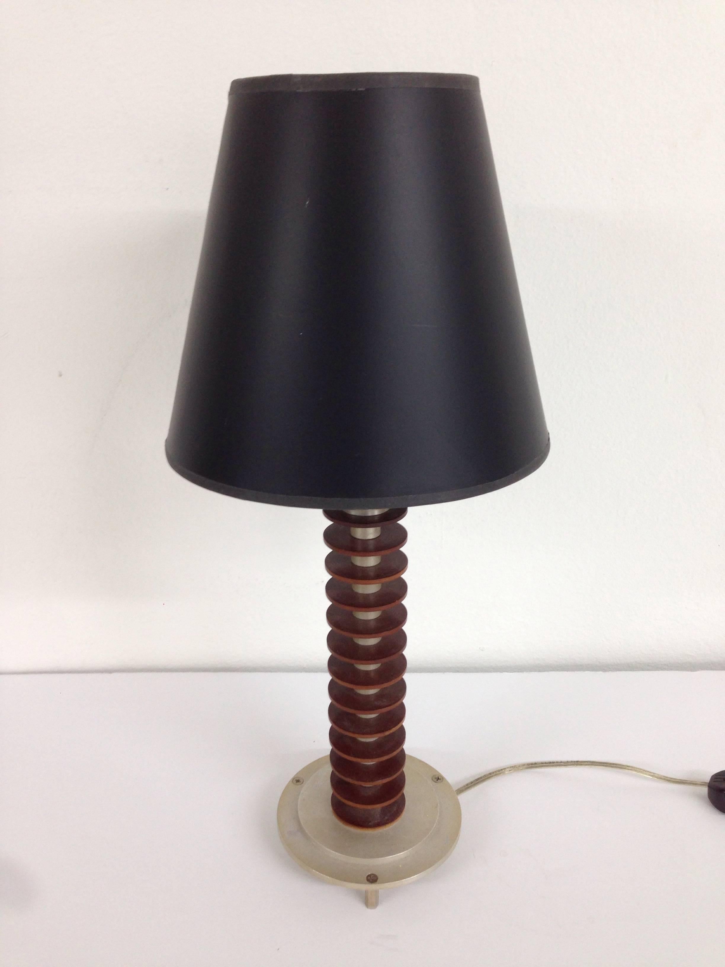 Pair of period Art Deco bedside table or occasional lamps in walnut and steel with black paper shades.