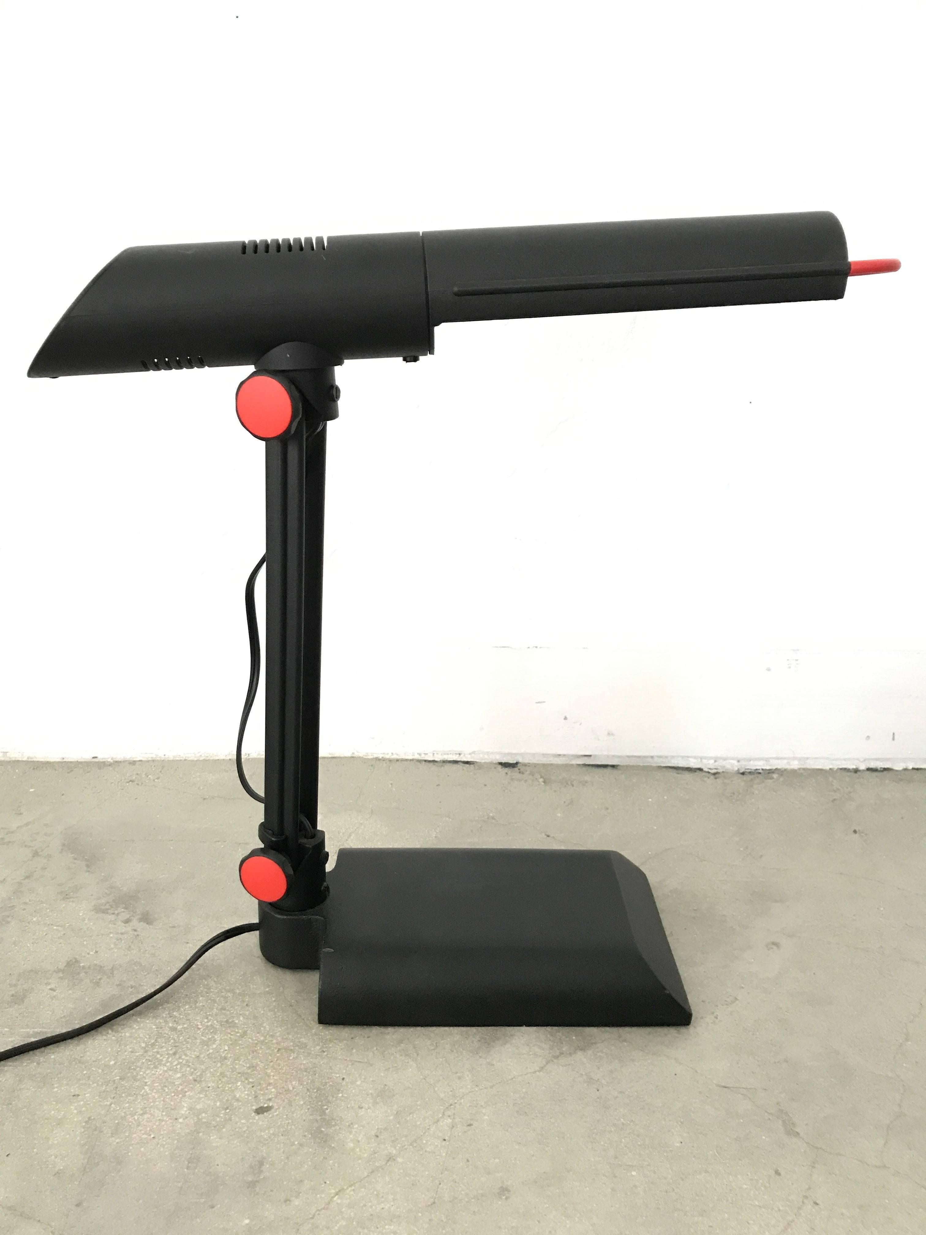 Postmodern articulating and adjustable desk task or table lamp rendered in red and black powder coated steel by Phillips, circa 1980s.