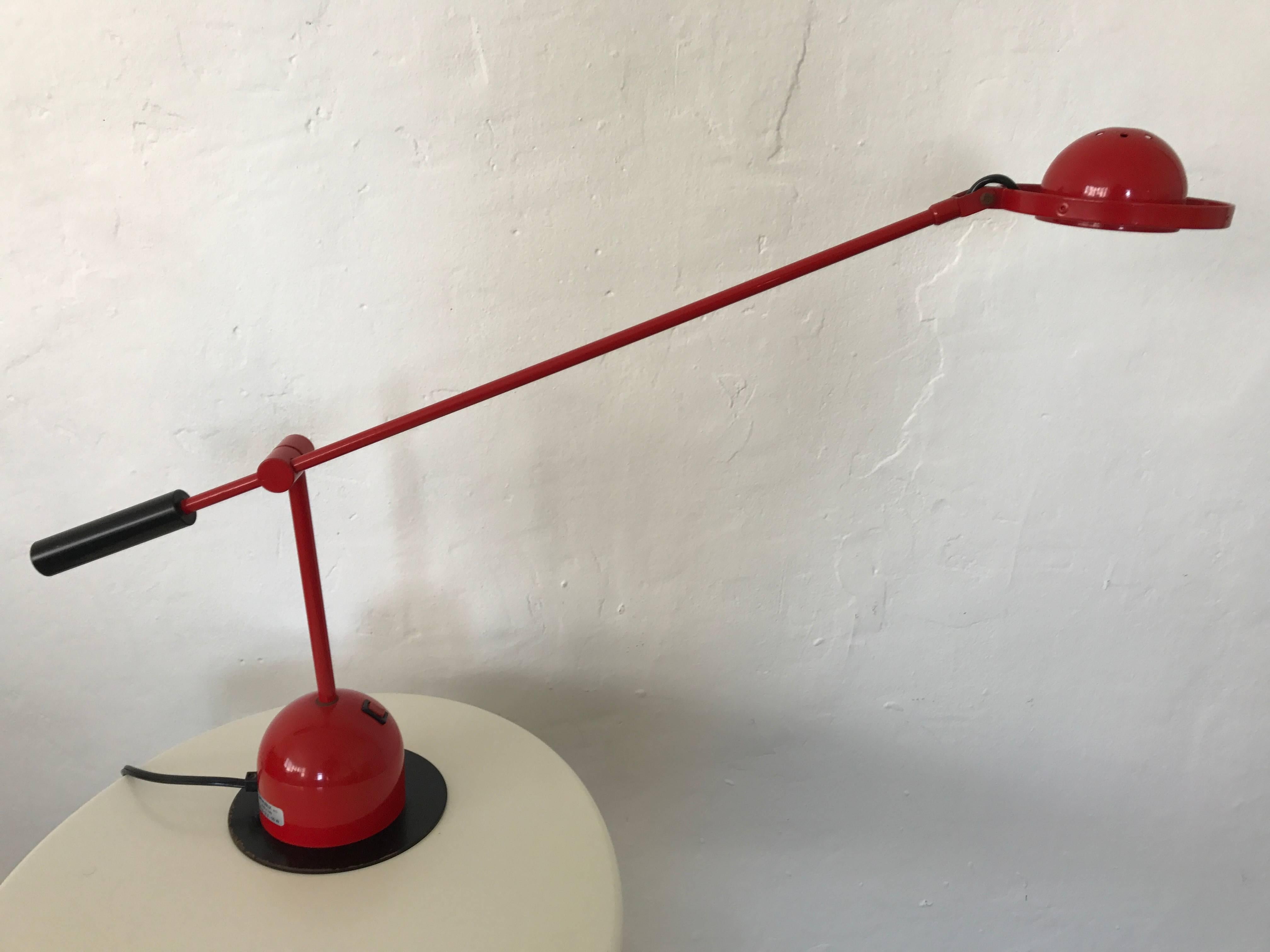 Postmodern articulating and adjustable desk task or table lamp with two way toggle in rendered in red lacquered steel by Gammalux, Italy, circa 1980s.