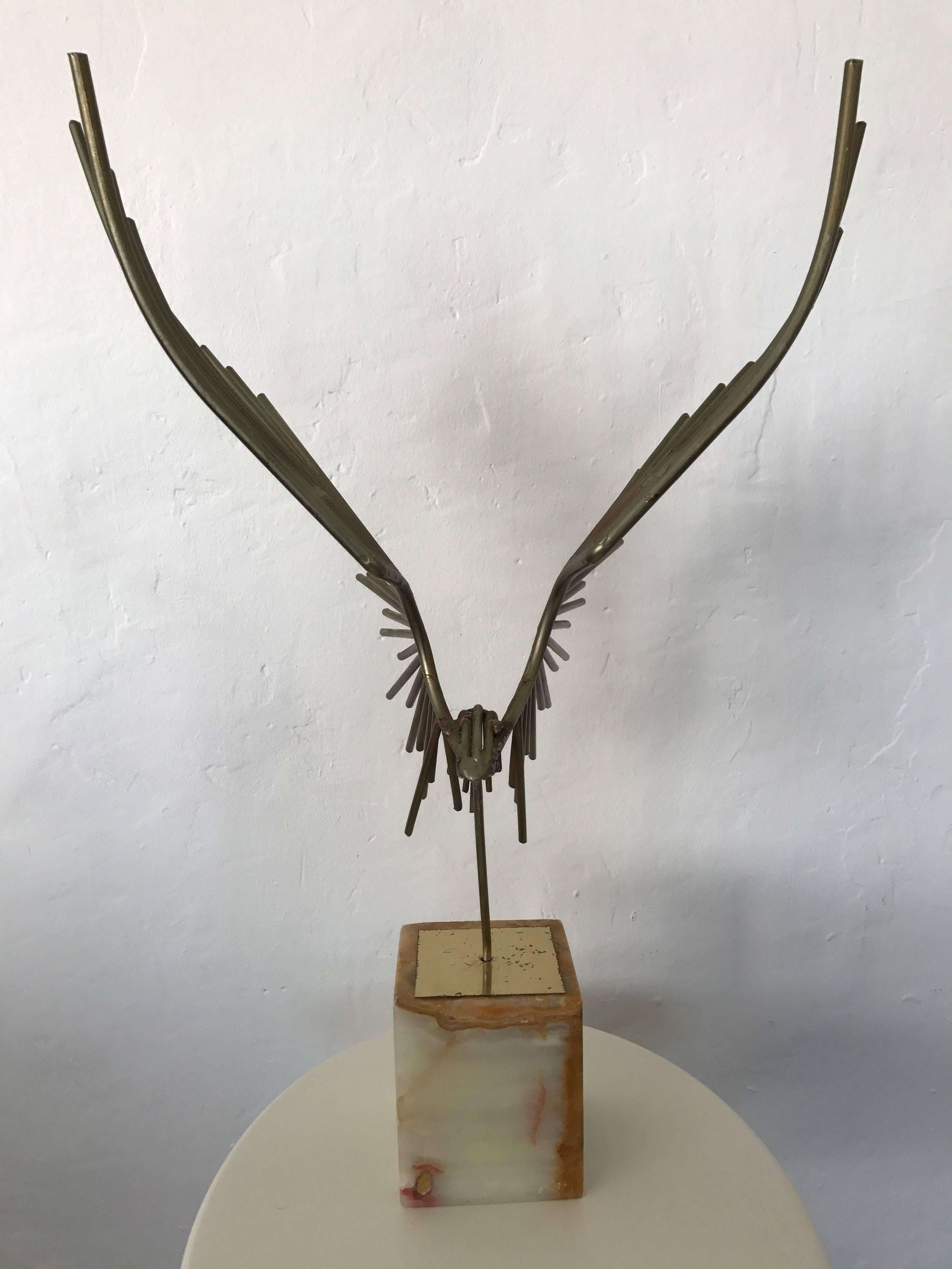 Patinated brass eagle sculpture on marble base by Curtis Jere.