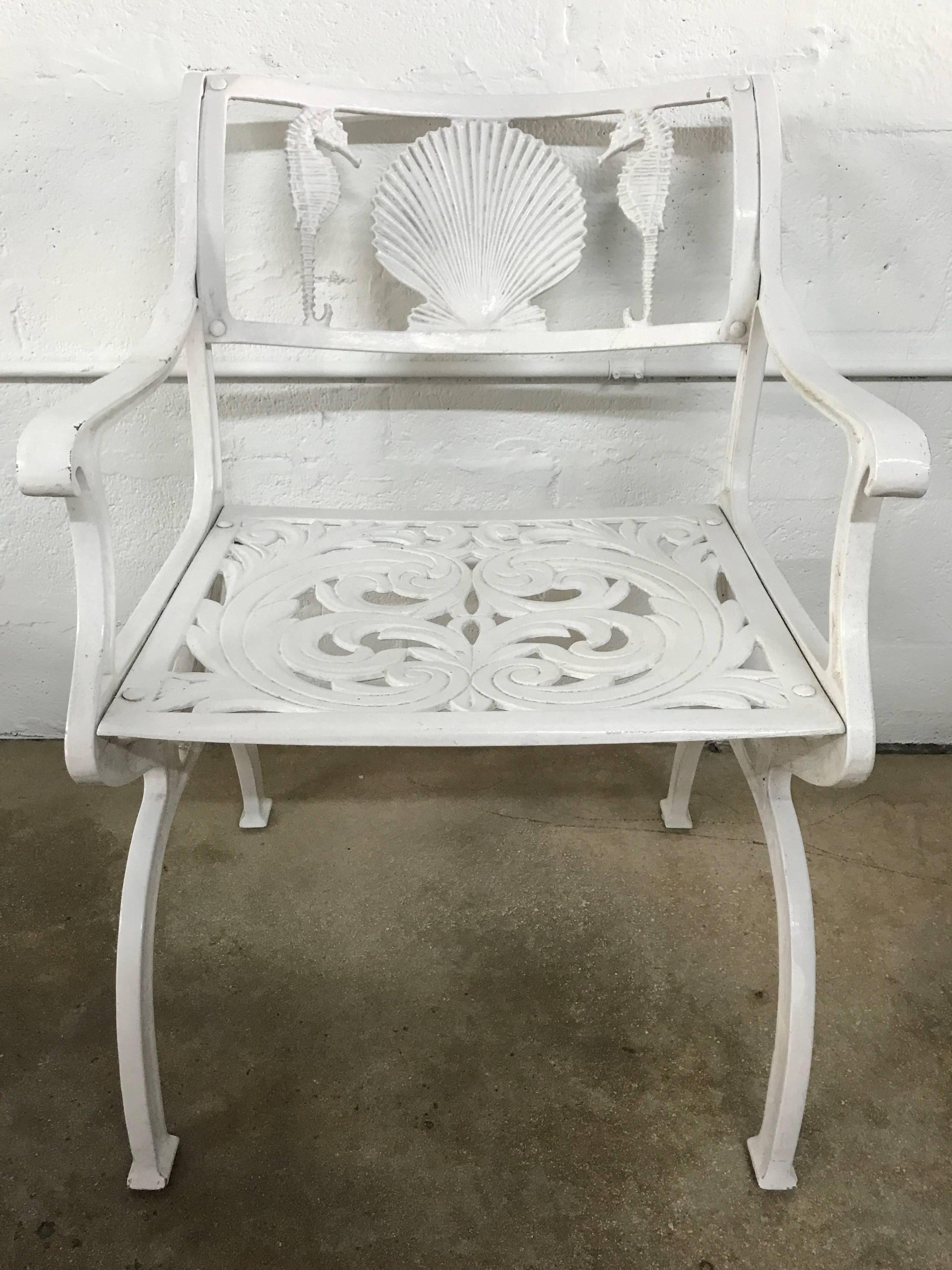 Three Molla chairs featuring a shell and seahorse motif back and filigree seat in original white powder coated aluminum.