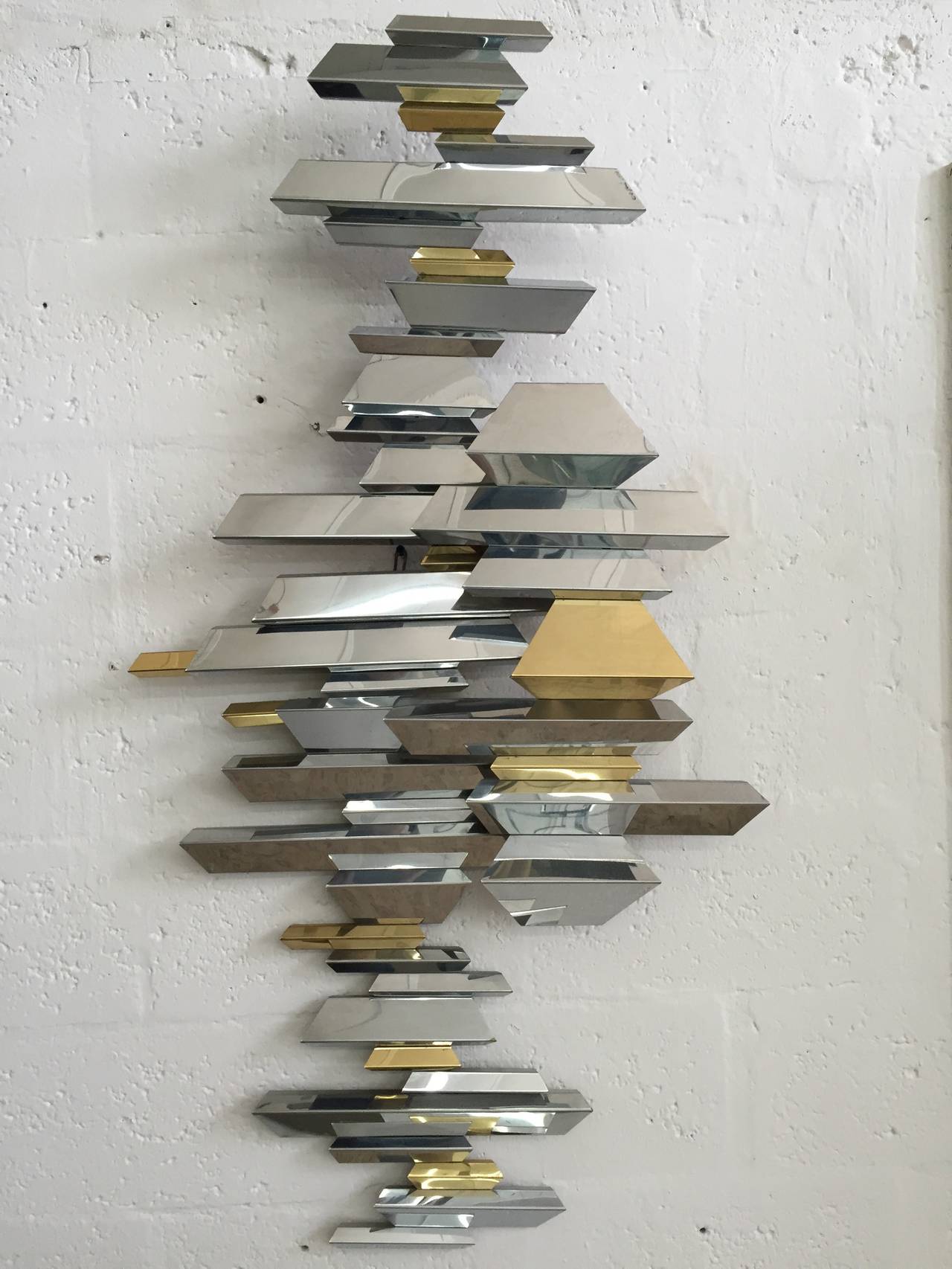 Wall sculpture in brass and chrome by Curtis Jere, signed.