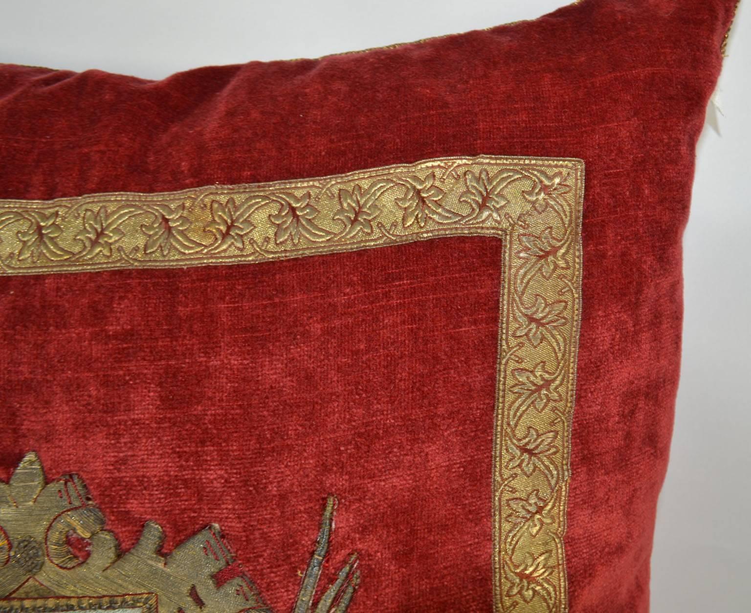 North American  Pillow with Red Velvet Fabric and Antique Trim and Crest