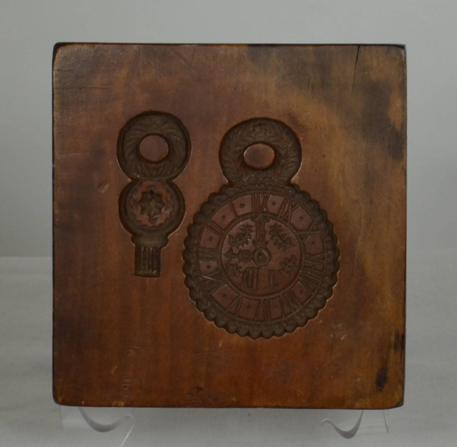 Wooden gingerbread mold (pocket watch with initials JD, and matching watch fob), circa 1889. Signed and dated on side T.W.