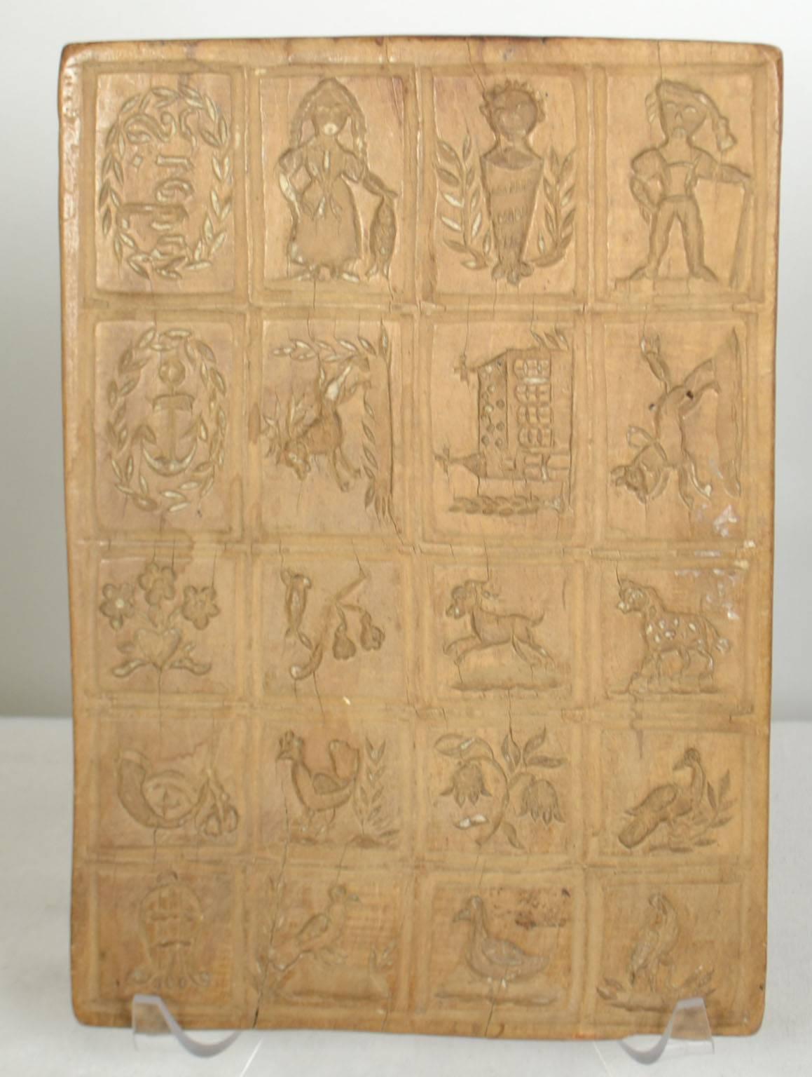 Wooden gingerbread mold (small squares with various figures, animals, flowers, church).