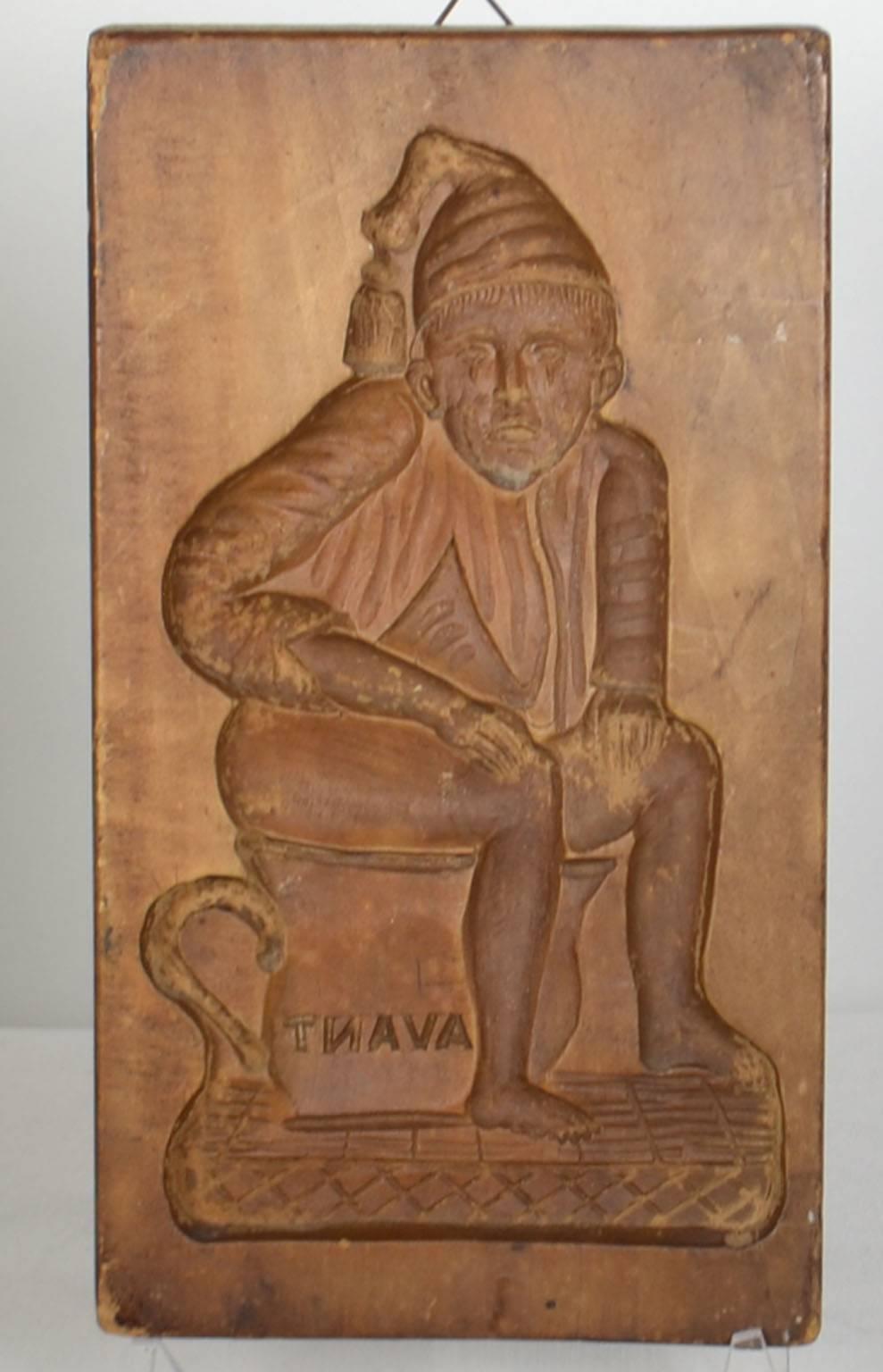 Wooden gingerbread mold (seated man).