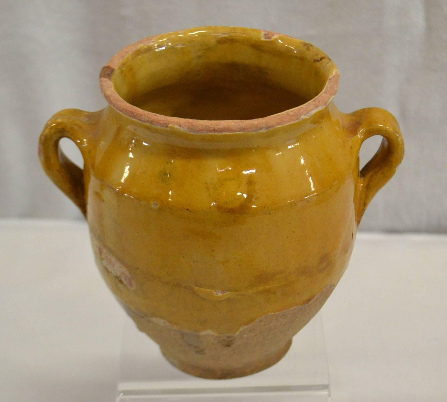 Small (rare) terra cotta pot with a gold glaze.Once a common piece of pottery used daily in French kitchens, these earthenware jugs have become showcase pieces sought by designers and collectors. These beautiful vessels offer a depth of color and a