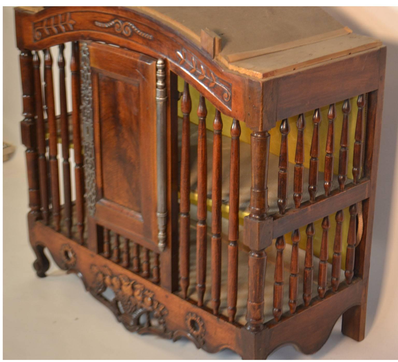 18th century Pannetiere in walnut from Provence, circa 1760. This piece is decorated with rare long key plates and hinges and spindle bars. On the apron rests a basket of fruit flanked by open sunflowers.