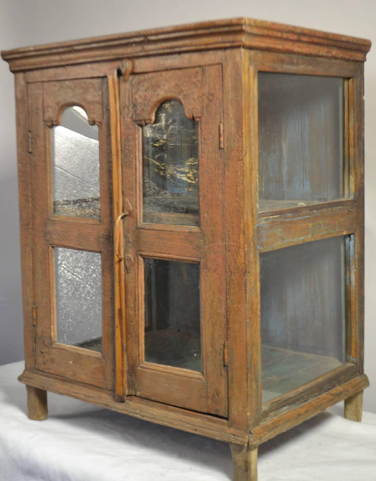 Small painted wood hanging shelf with glass doors, circa 1790.