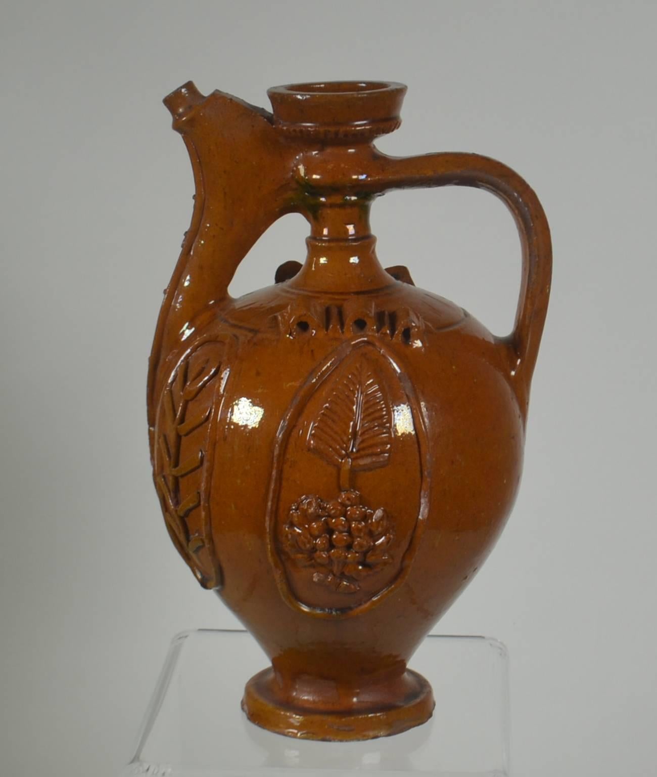 Earthenware pitcher 'Brown with relief design,' circa 1900. Once a common piece of pottery used daily in French kitchens, these earthenware jugs have become showcase pieces sought by designers and collectors. These beautiful vessels offer a depth of