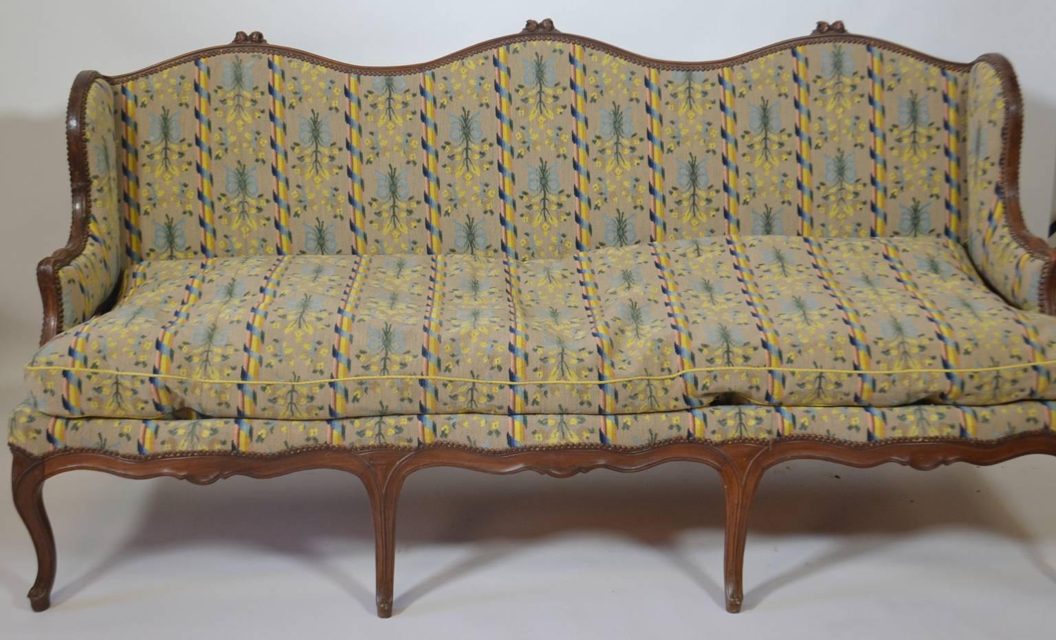 Louis XV period canapé in walnut with antique petit-point covering.