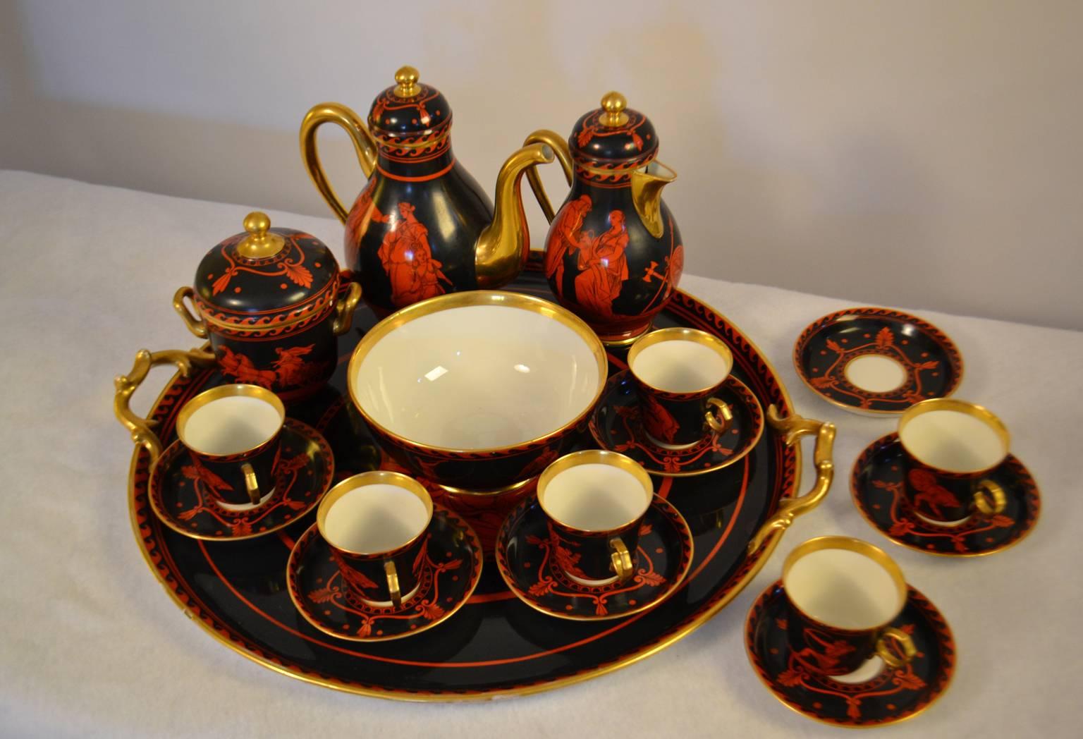 A mid to late 19th century Etruscan style red, black, and gilt porcelain coffee service, marked Fischer & Mieg, comprising coffee pot, milk jug, waste bowl, six cups, and seven saucers, and a tray, decorated with Classical figures, Athenia and