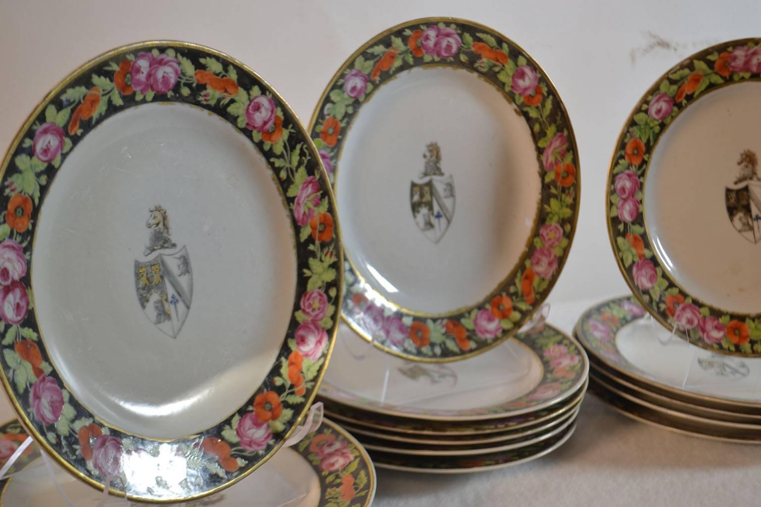Set of 16 Chinese Export porcelain armorial dessert plates, circa 1800, each plate with a black-ground border of hand-painted roses and decorated with the arms of Smyth of Walsham and Old Buckenham impaling Denison.