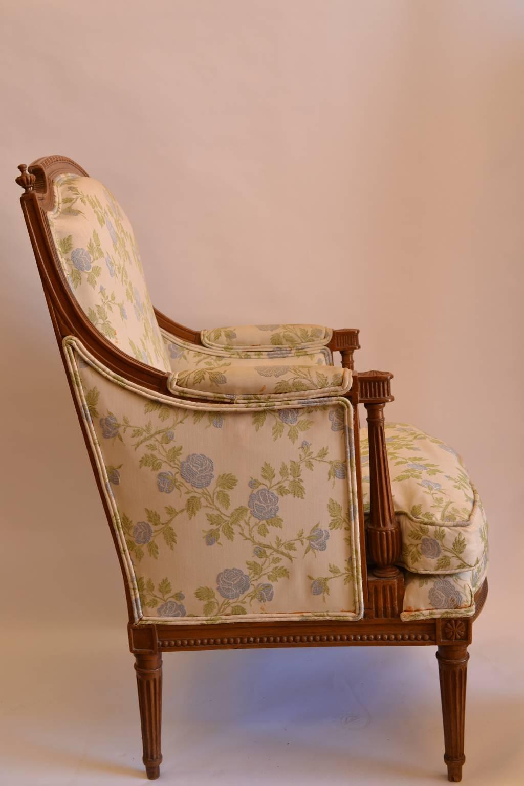 A Louis XVI carved walnut Bergère, late 18th century, Georges Jacob (1739-1814, maître in 1765), stamped, arched crest rail, lobed finials, padded arms, fluted and reeded uprights, beaded seat rail, rosette blocks, tapered fluted legs.
