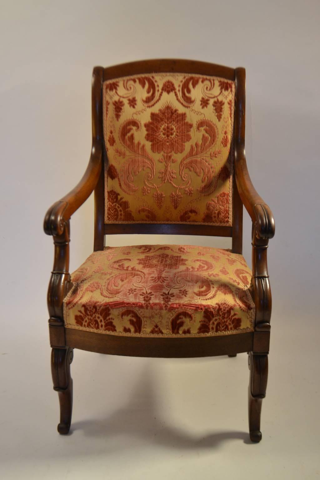 Pair of Louis-Phillippe carved mahogany fauteuils, early 19th century, each with shaped crest, lappet carved arms, rounded seat rail, lappet scrolled legs.