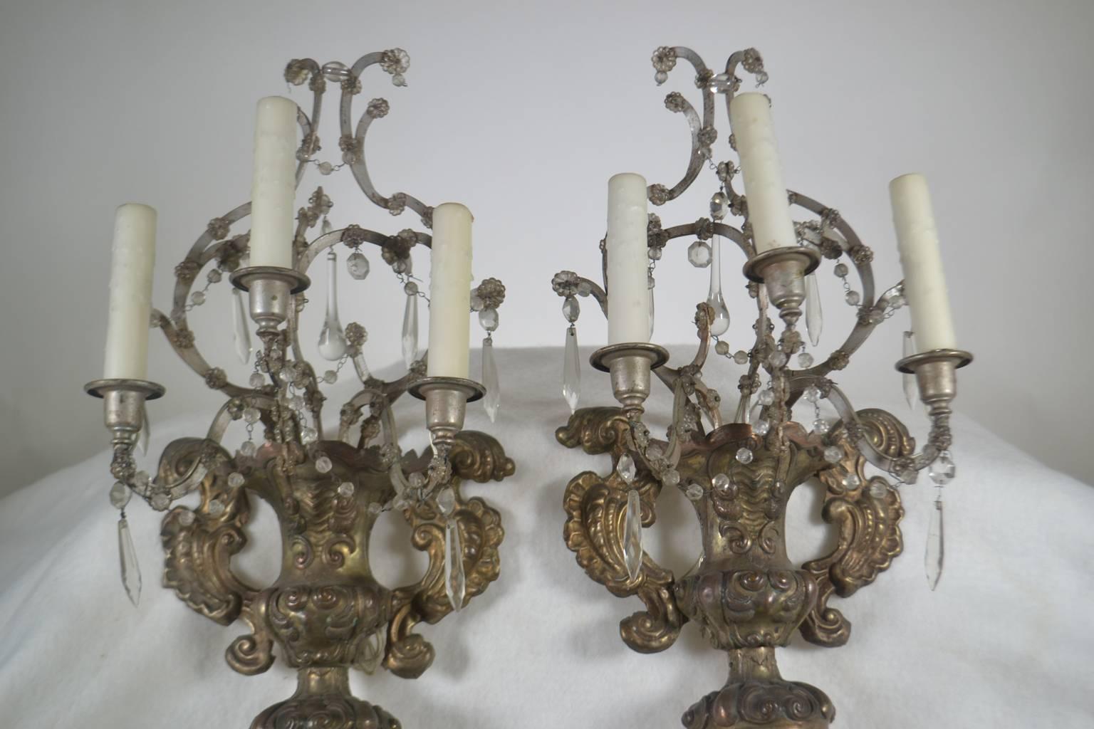French, 18th century, pair of silver reposse three-arm wall sconces with crystals.