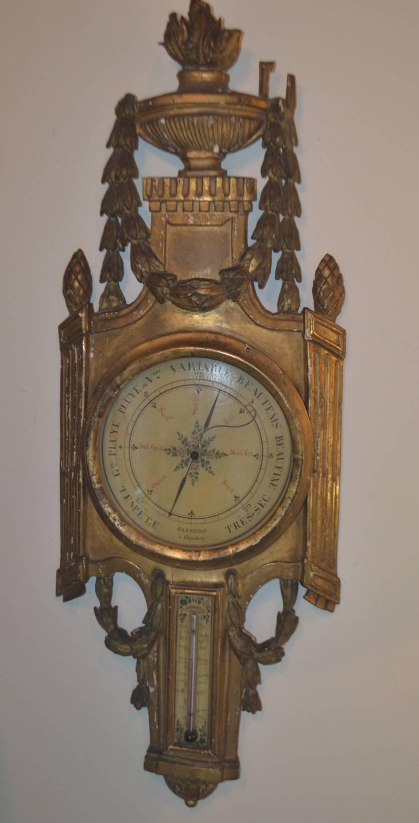 An elegant French gilded wood barometer with thermometer (period Louis XV, circa 1760). The face is signed (Bartesago and Chaunbery).