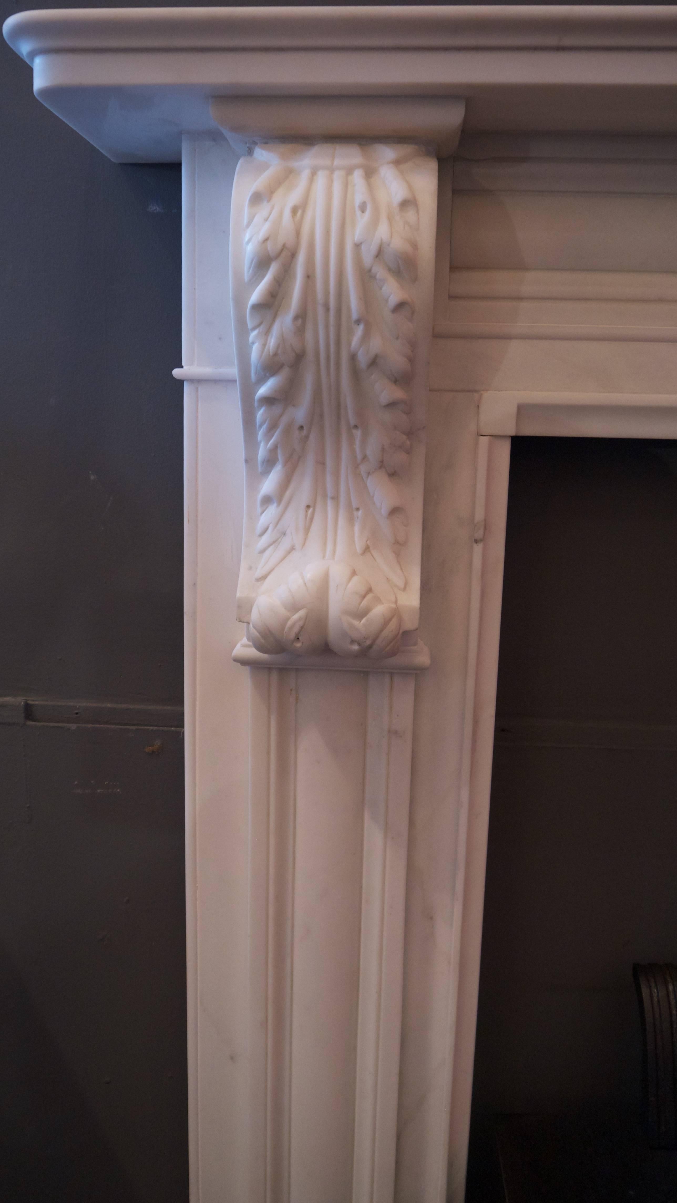 Original antique Irish Statuary white Georgian carved marble corbel fireplace.