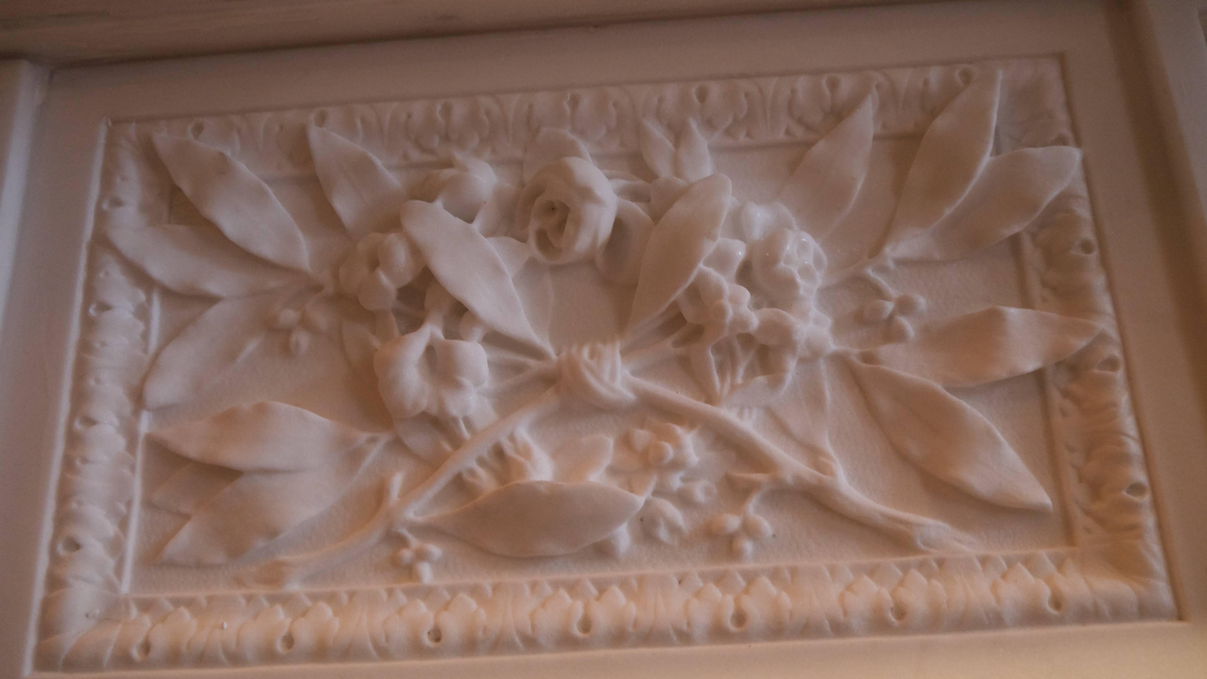 A very impressive original heavily carved statuary white Louis XVI marble surround with acanthus leaf decoration.