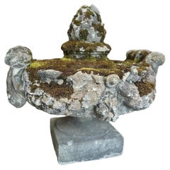 19th-century stone pediment with Corinthian scrollwork, and an Artichoke Finial