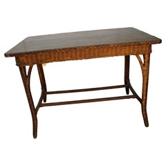 Natural varnish on this American Antique wicker table, w/ braided edge + Oak top