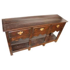 English stained dark pine dresser base with 3 drawers, brass handles, + shelf.