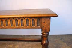 English Oak long joint stool or bench, C. 1900, with a decorative frieze.