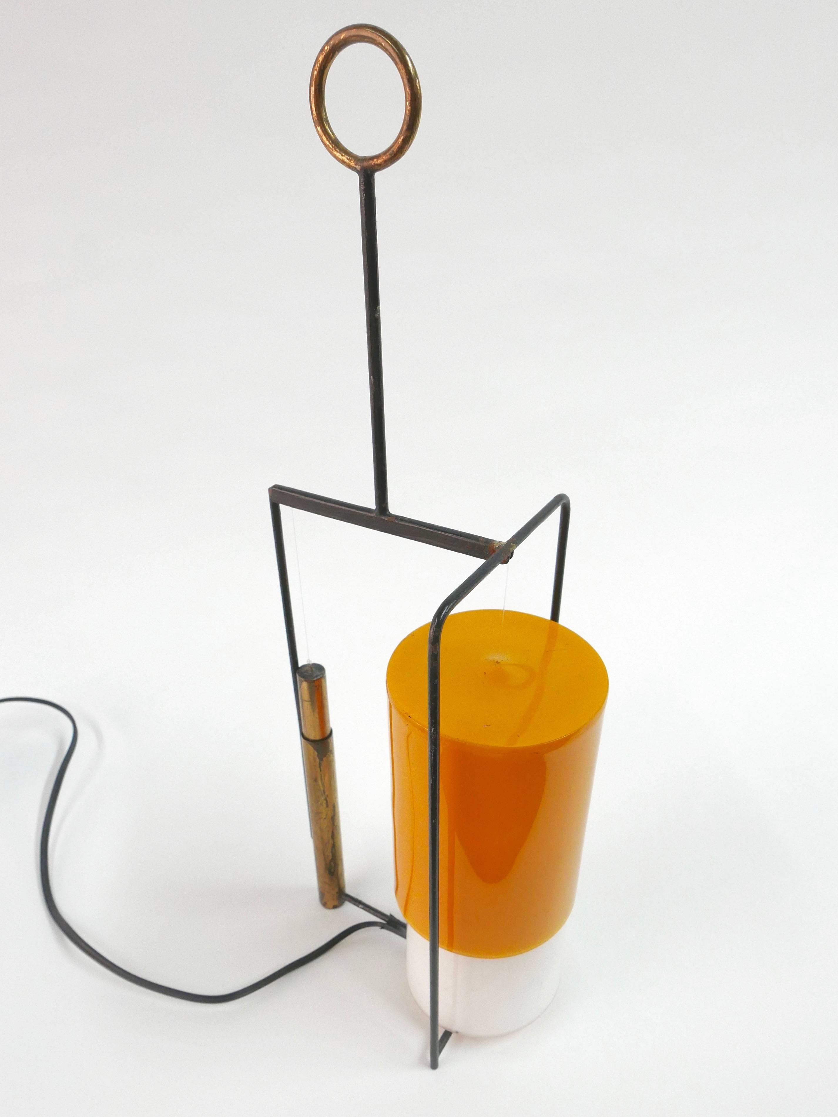 Arredoluce table lamp designed by Angelo Lelli in 1955.
The Yellow Perspex shade is counterbalanced by a brass counterweight and adjusts up and down.
 