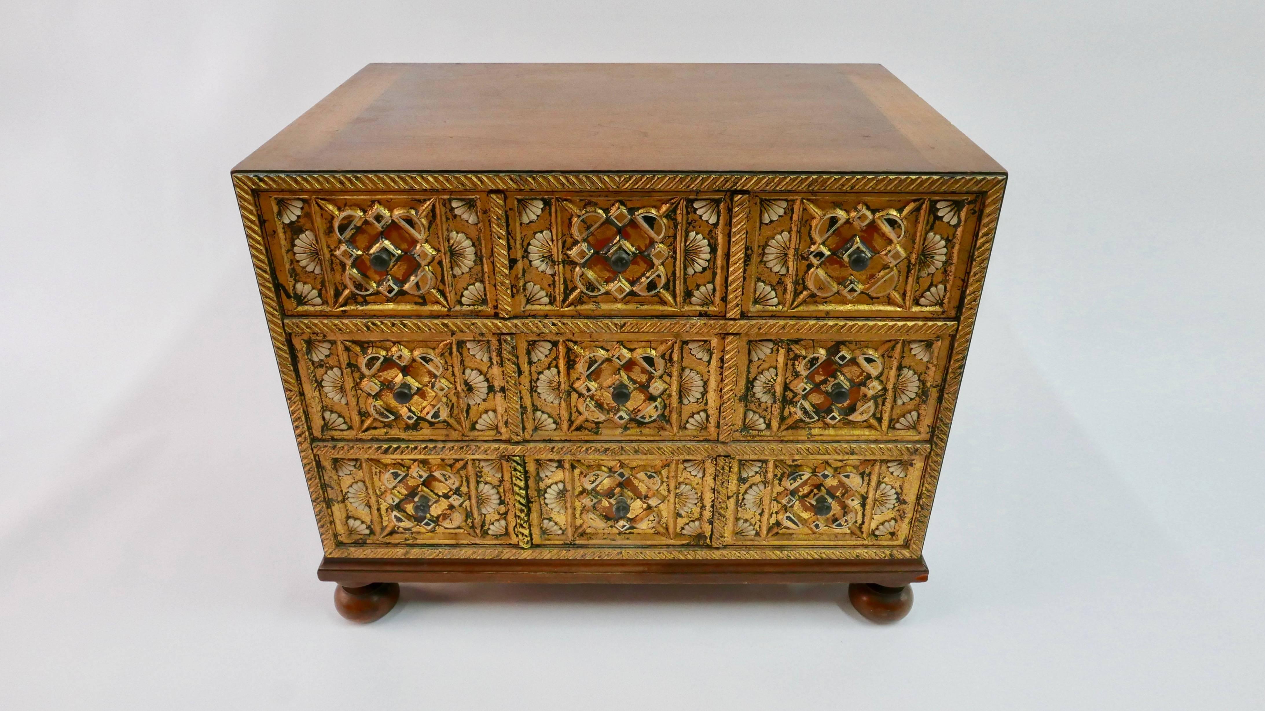 A small cabinet with three drawers. Hand-carved drawer fronts with gold-leafed accents.
Designed by William A. Berkey and manufactured by Widdicomb Furniture.
  