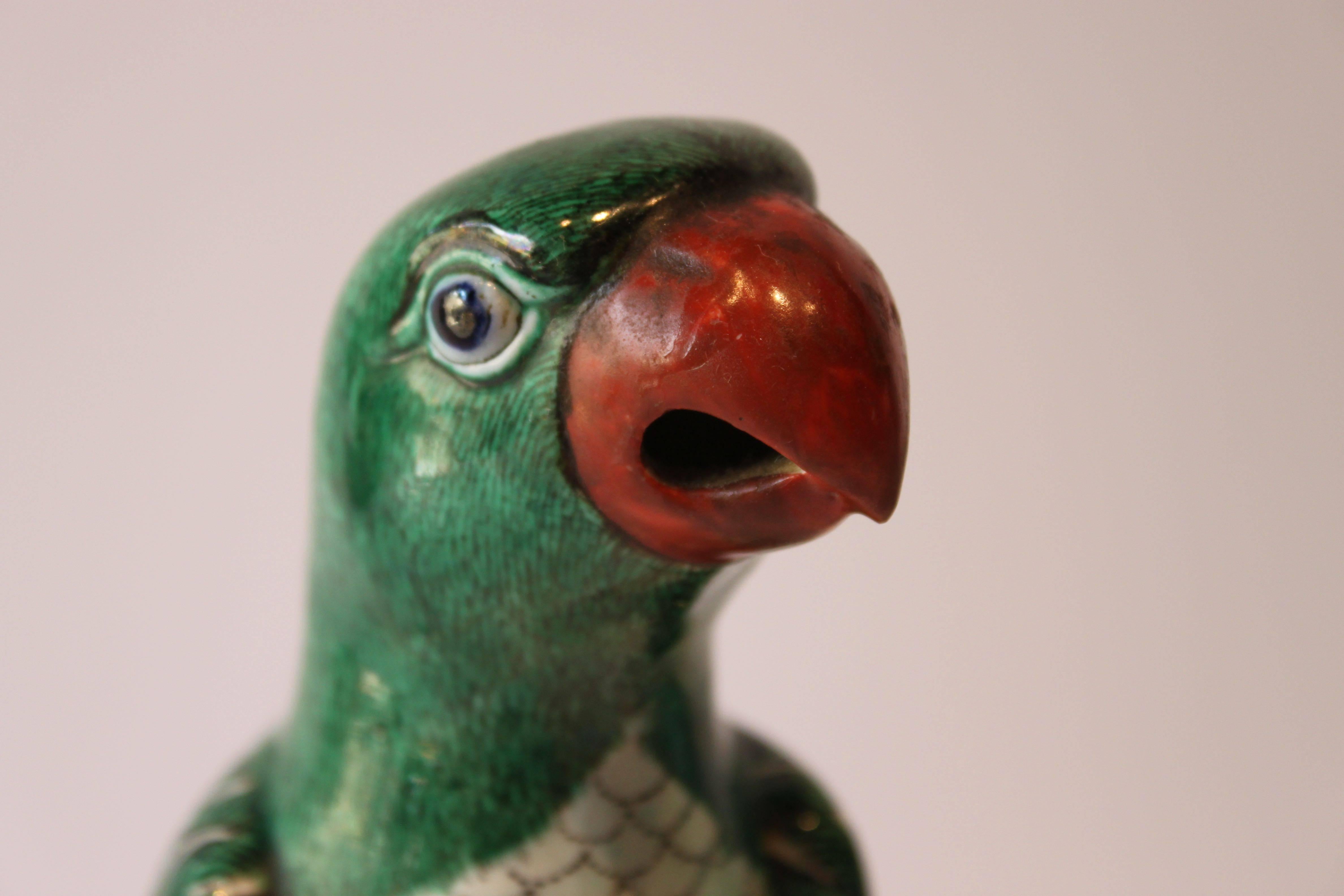 Charming pair of Chinese export famille vert hand-painted ceramic parrots. These are likely from the late 19th century or early 20th century. They are each impressed with the mark 