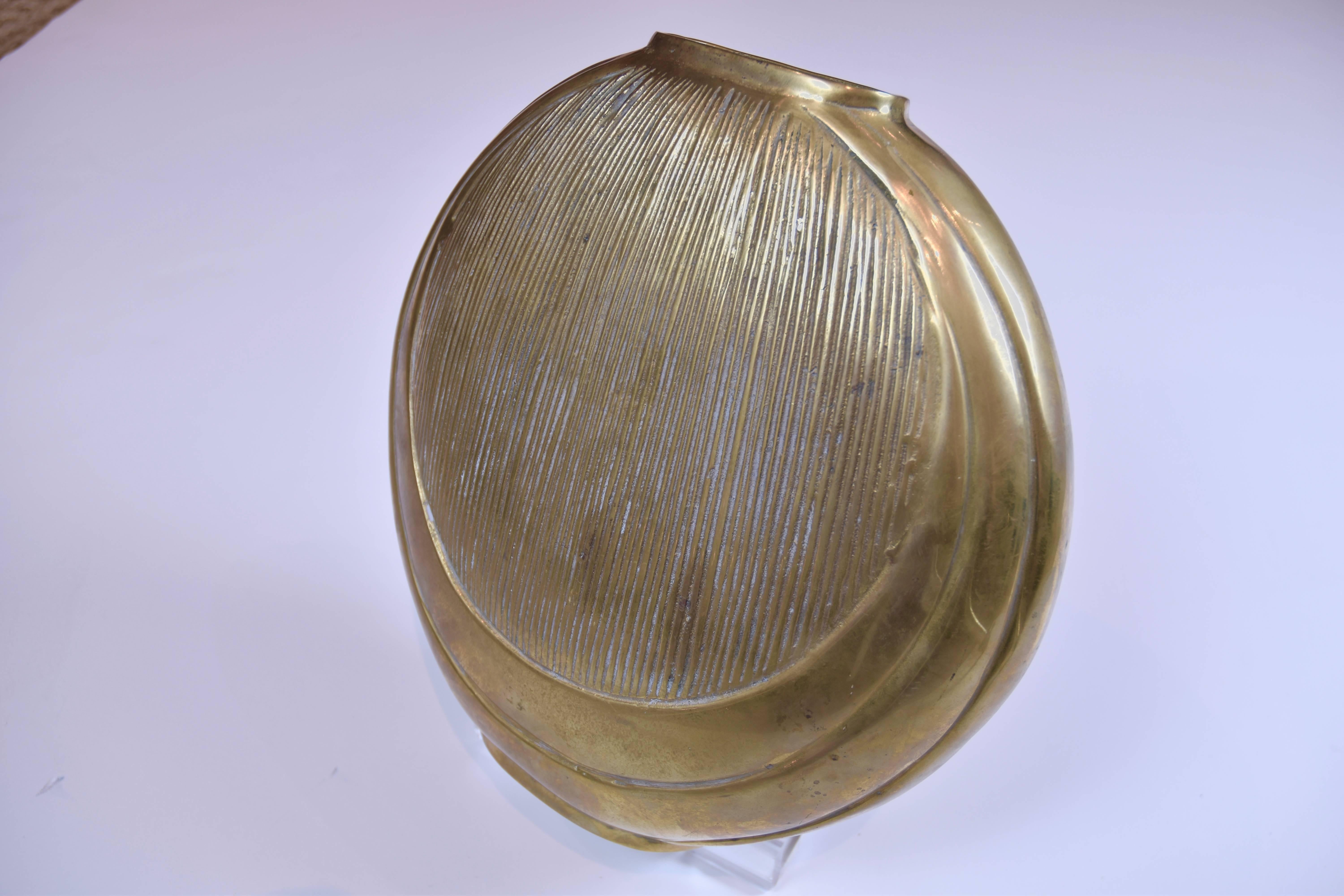 Contemporary brass circular form vase.