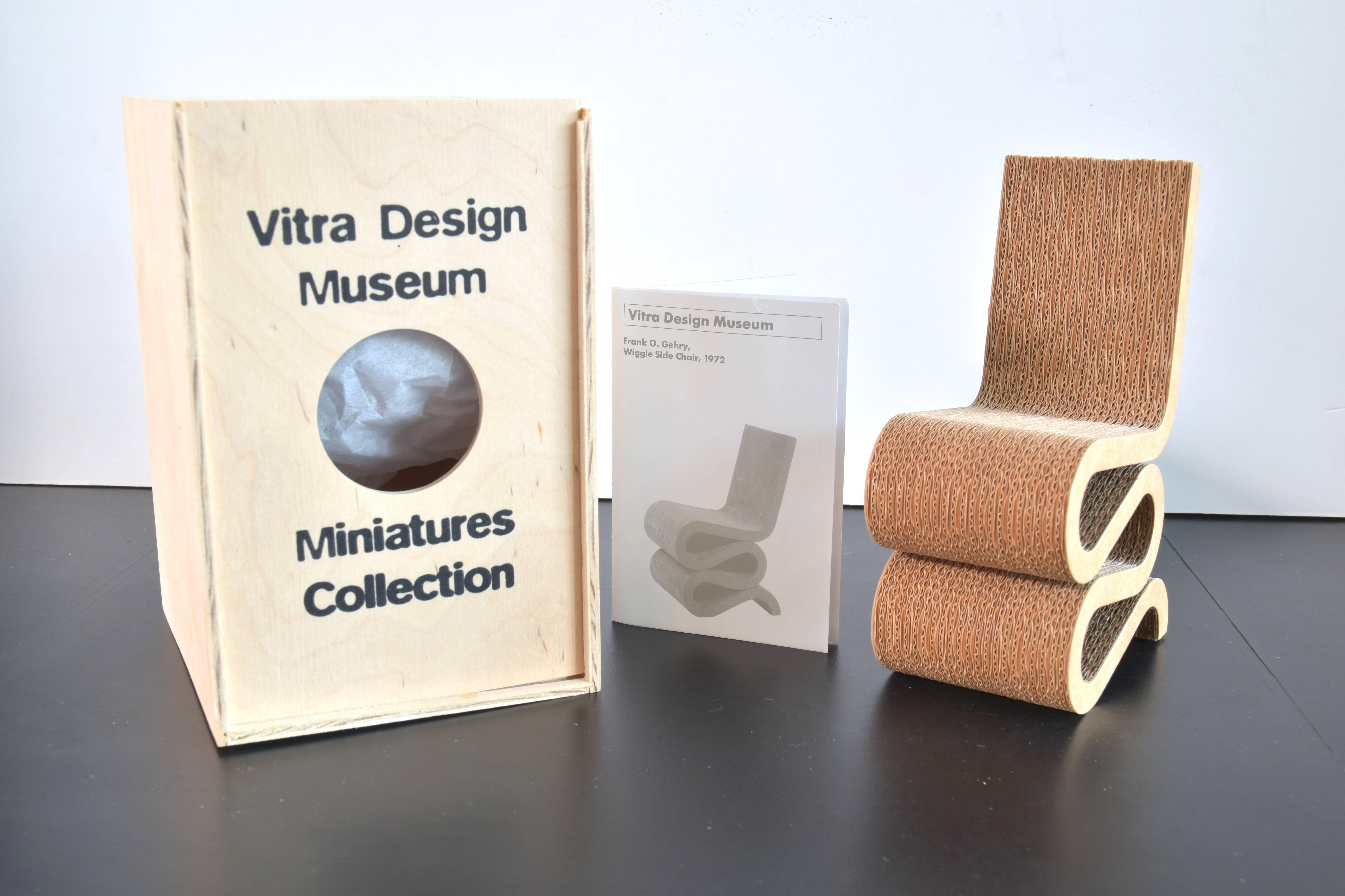 From the Vitra Design Museum collection of miniatures a model of the Frank Gehry Wiggle Side Chair originally produced in 1972.

Included are the original wooden box and historical narrative brochure describing designer and the piece as noted
