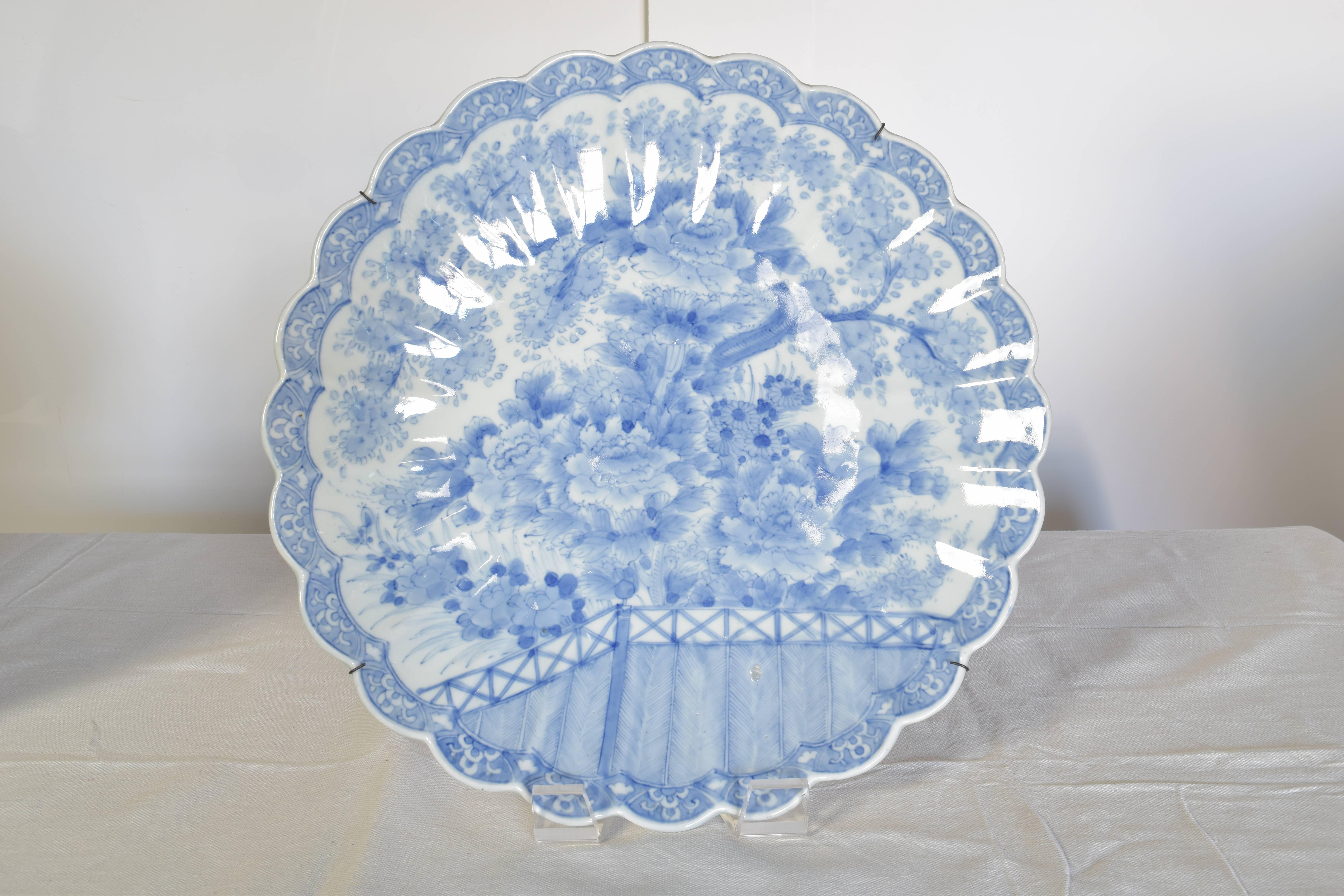Lovely pair of blue and white chargers with scalloped edges. Each is hand-painted with chrysanthemum decoration and signed.