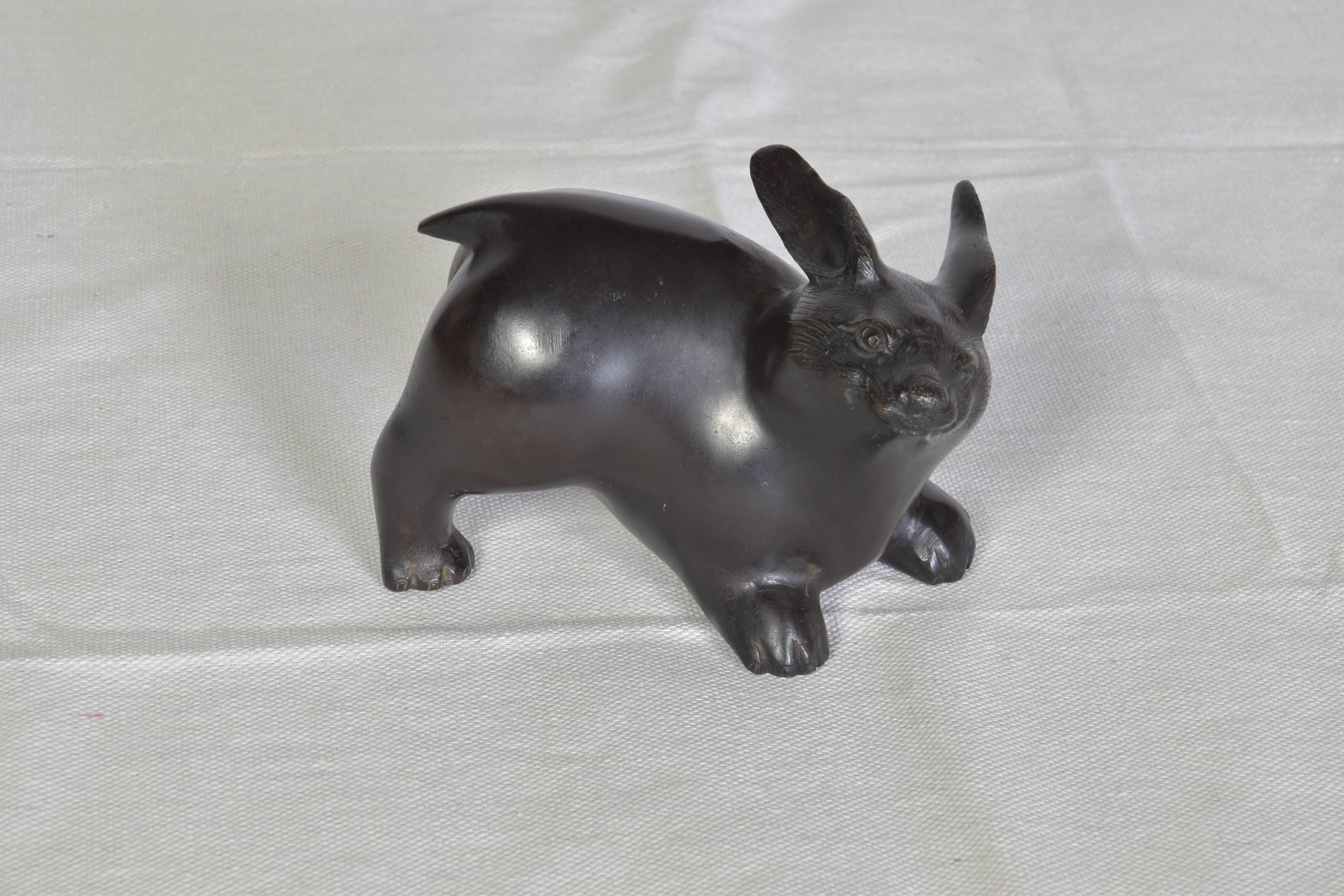 Charming bronze rabbit in a playful pose.