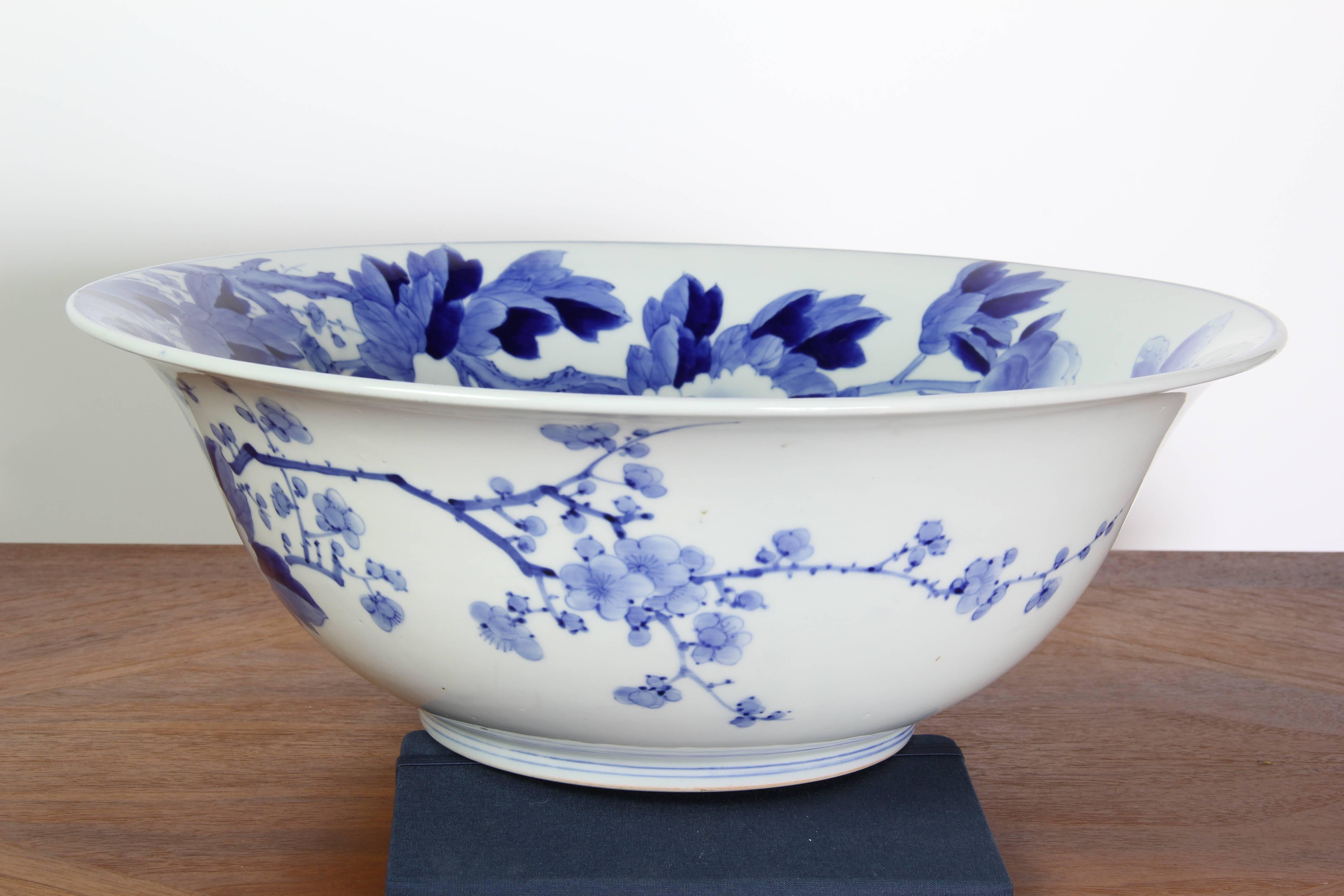 One-of-a-kind, hand-painted flowers and butterfly glazed in stunning blue and white design.